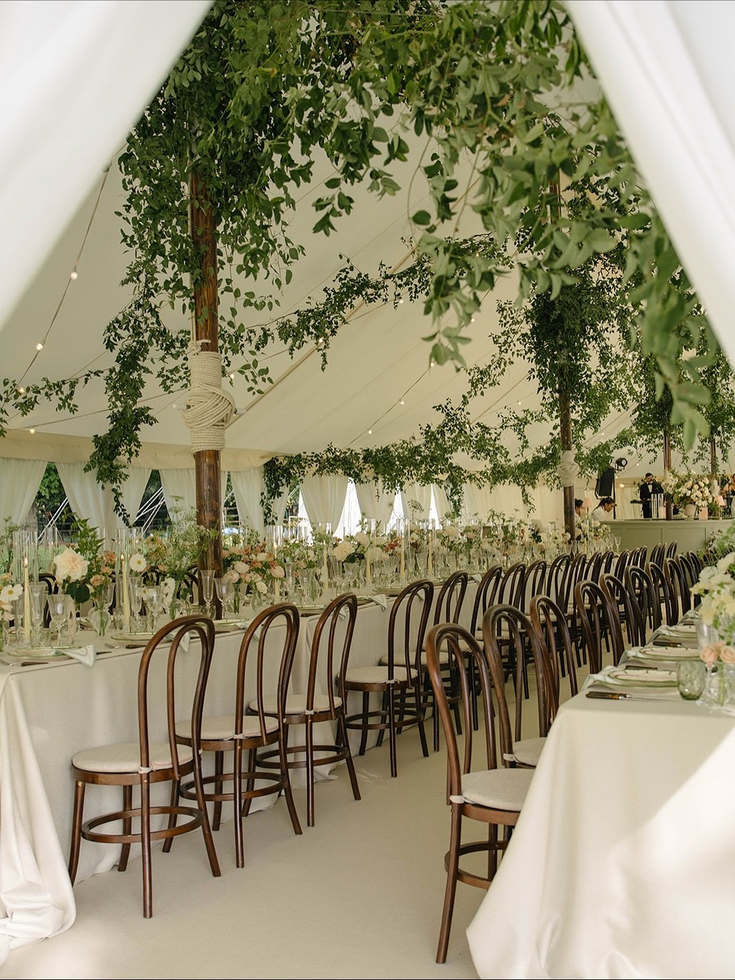 Quiet, flower filled luxury for a marquee wedding in the English countryside. We layered blousy roses, wisps of phlox, dancing cosmos, blackberries and many more seasonal favourites together to create a curated bud vase table scape that felt thoughtf