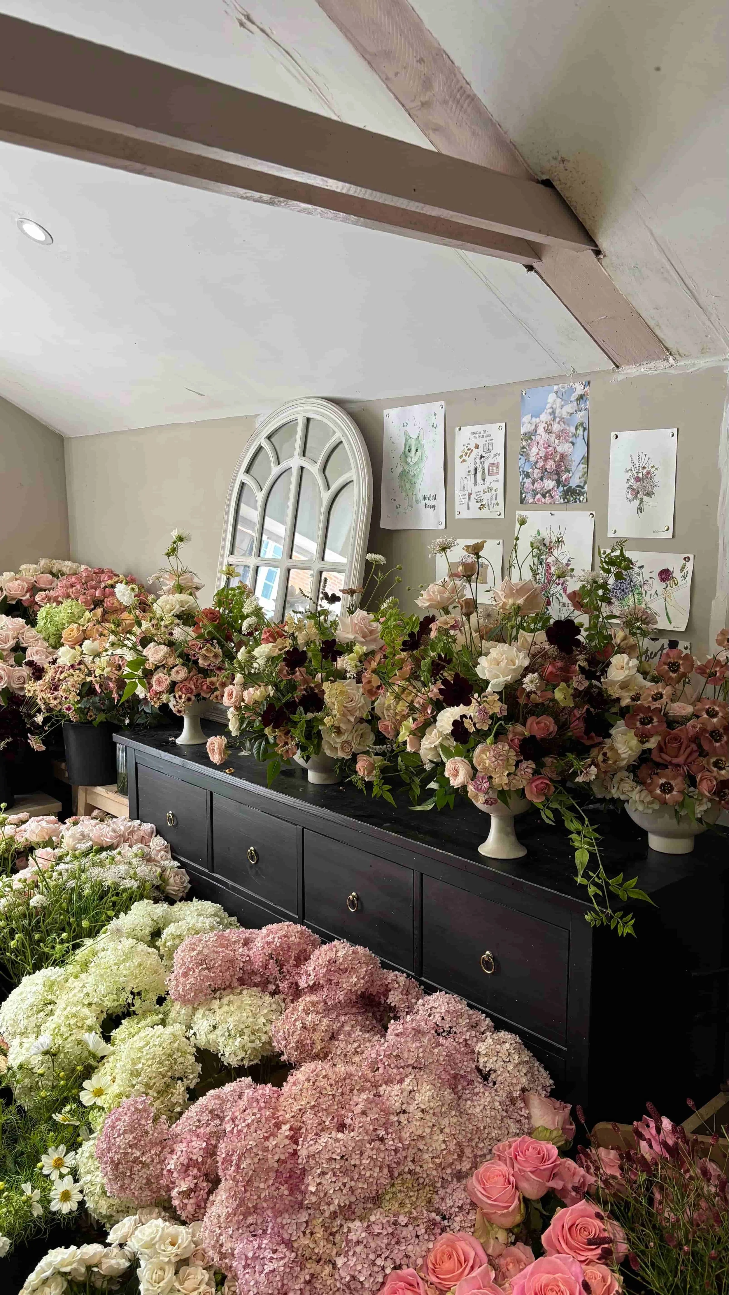 Garden-style wedding arrangements in pink, cream and burgundy tones ready for a Wilderness Reserve wedding