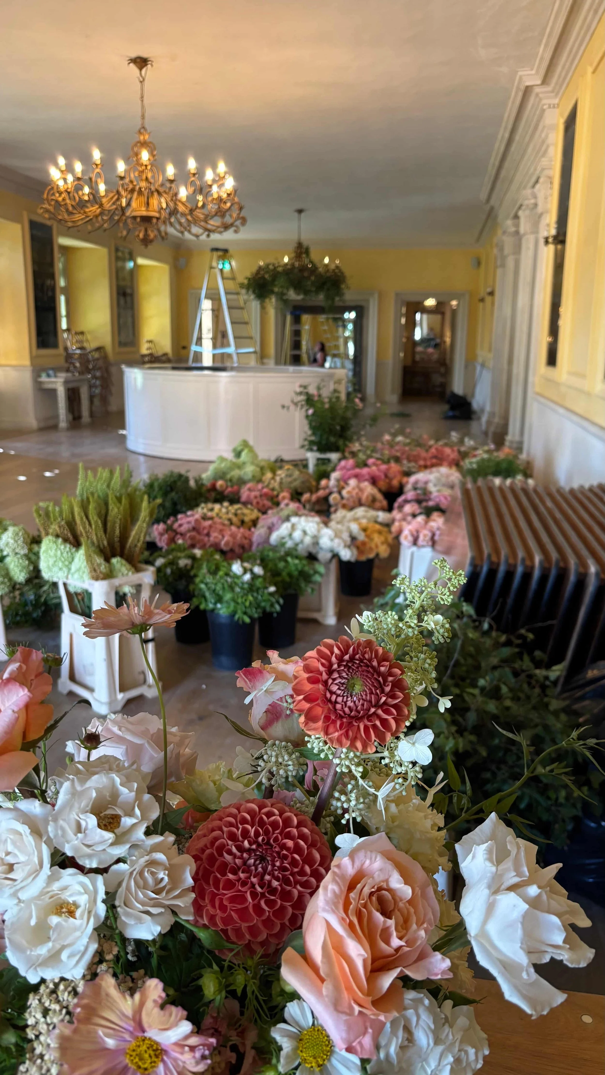 Peach, pink and cream wedding flowers being prepared on site at Euridge Manor in the Cotswolds