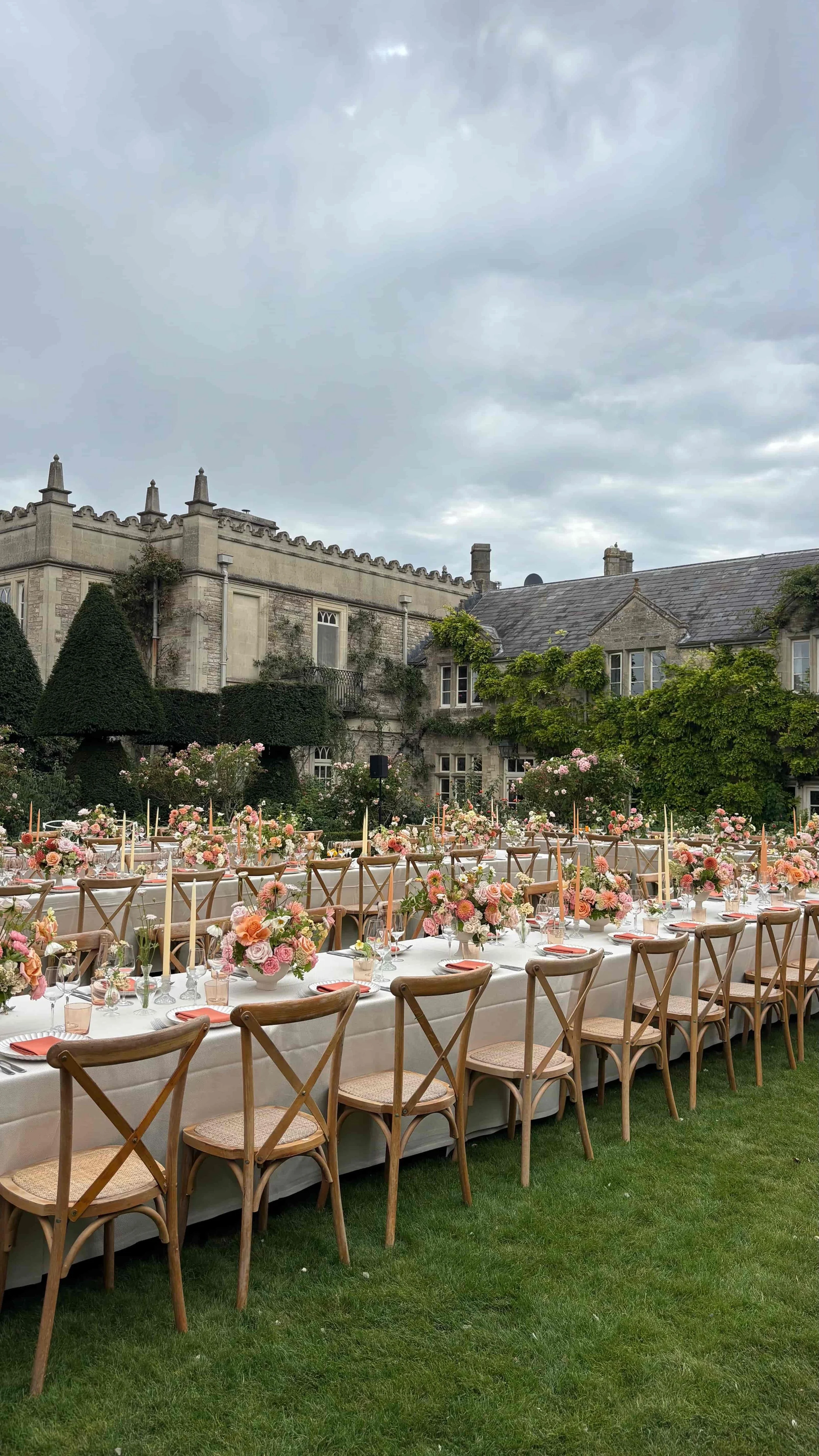 Romantic outdoor wedding tablescape with pink, peach and apricot garden-style flowers at Euridge Manor