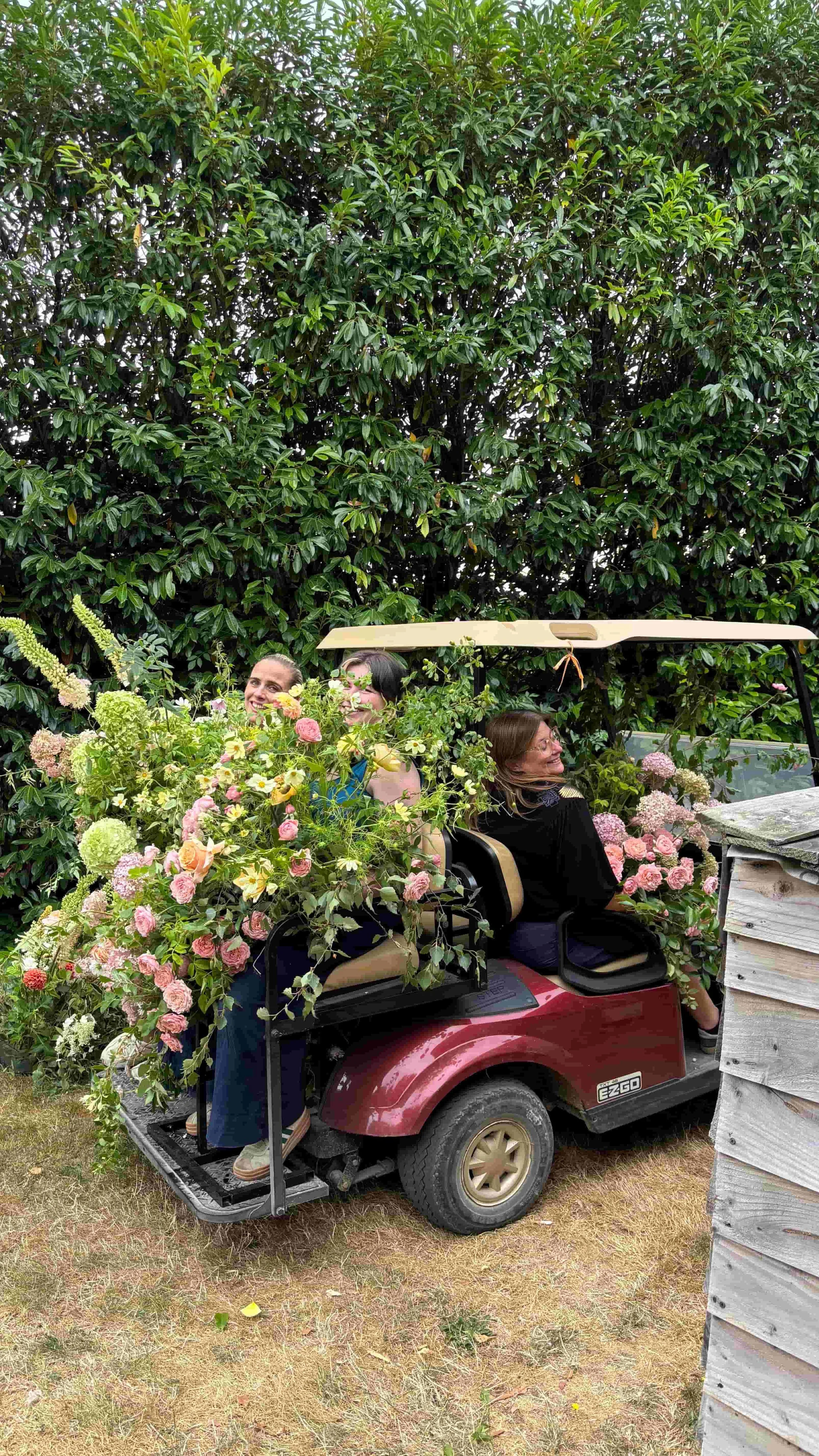 The Botany House floral team transporting wedding flowers by golf buggy across Euridge Manor
