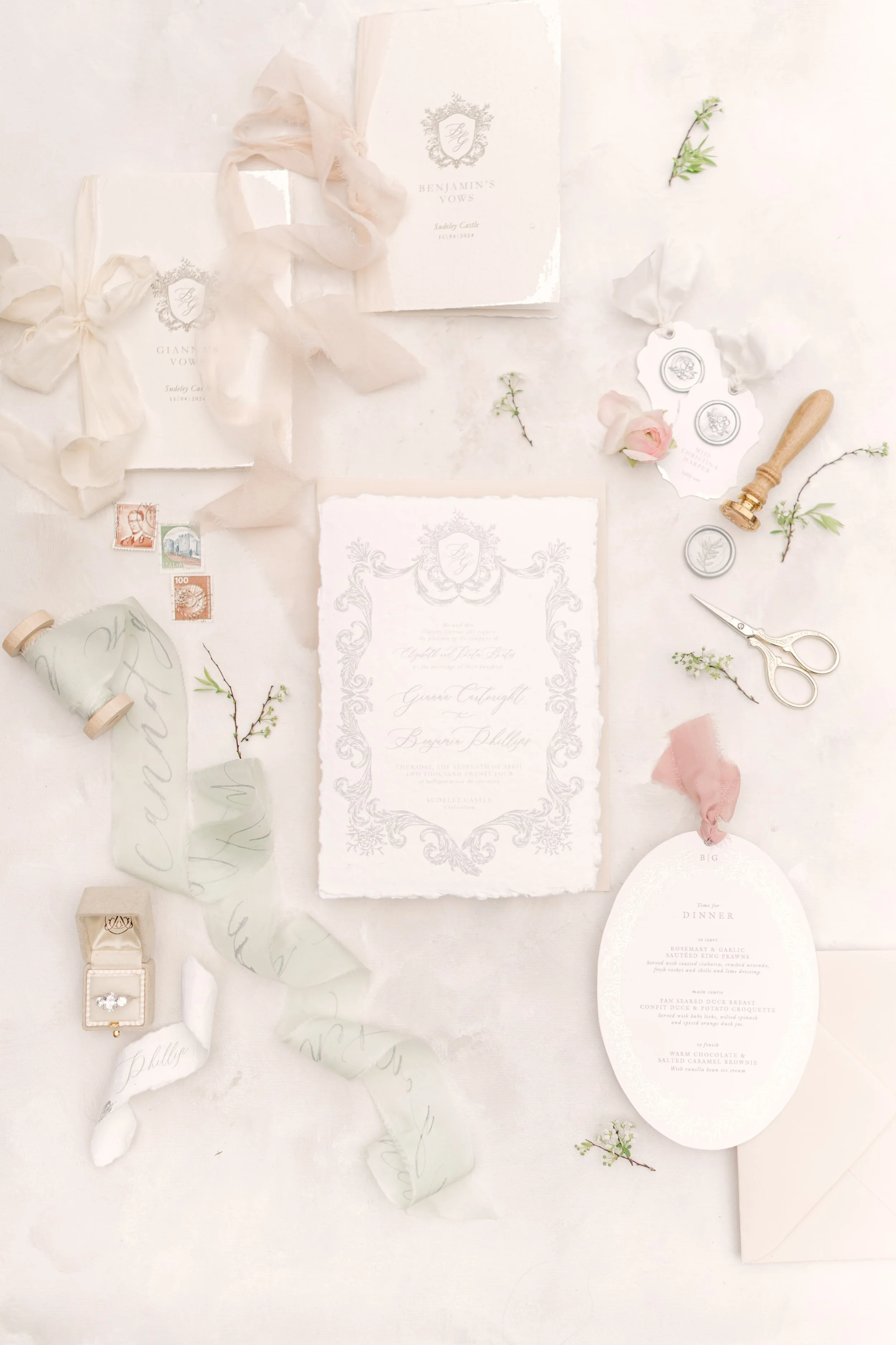 Wedding invitation stationery with floral accents, ribbons, seals, a stamp, and wedding details on textured paper. Sudeley Castle The Cotswolds, Florals by The Botany House