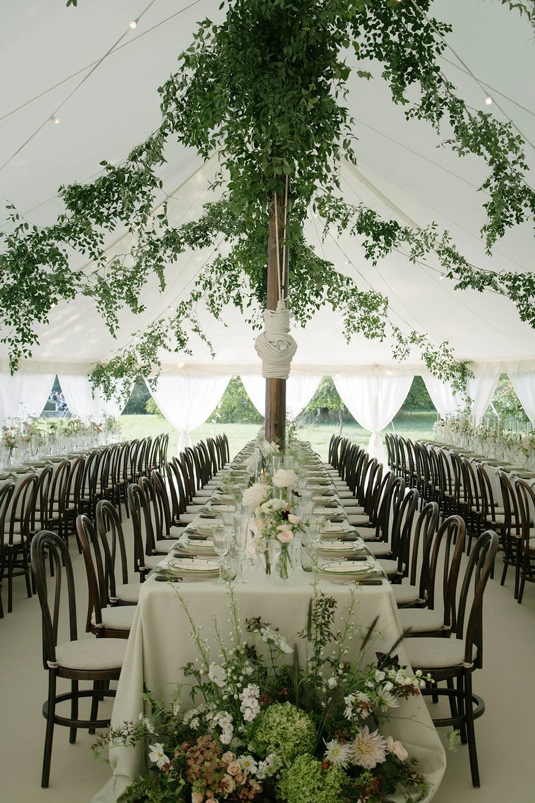 Elegant Cornwell Manor wedding table with blush and white floral centrepieces tall glass candles and menu cards styled by The Botany House wedding florist
