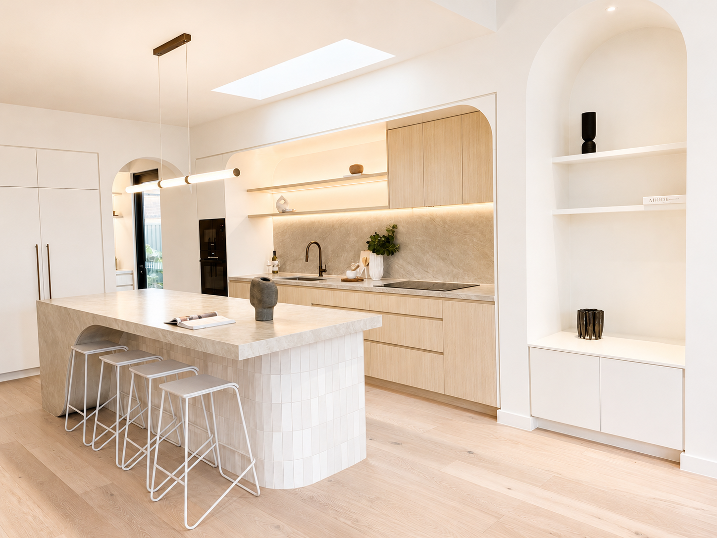 Designer kitchen in the Kirrawee duplex featuring a stone island bench, custom joinery, integrated appliances and architectural curved detailing.