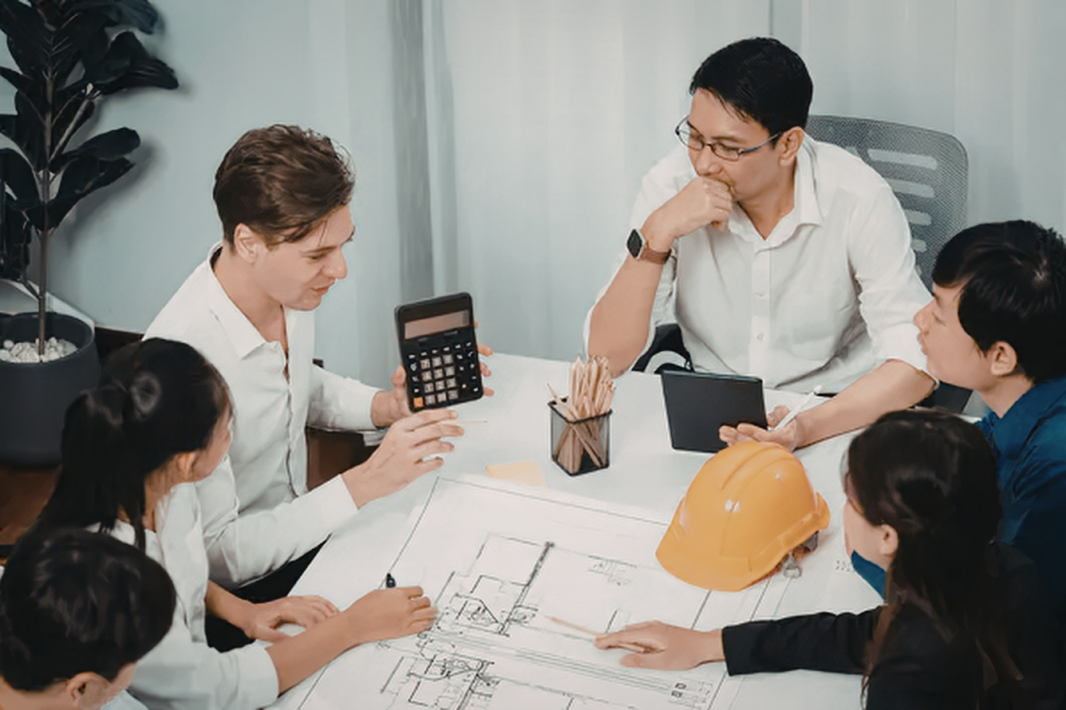 Homeowners and builders reviewing plans and costs together to improve communication during a build