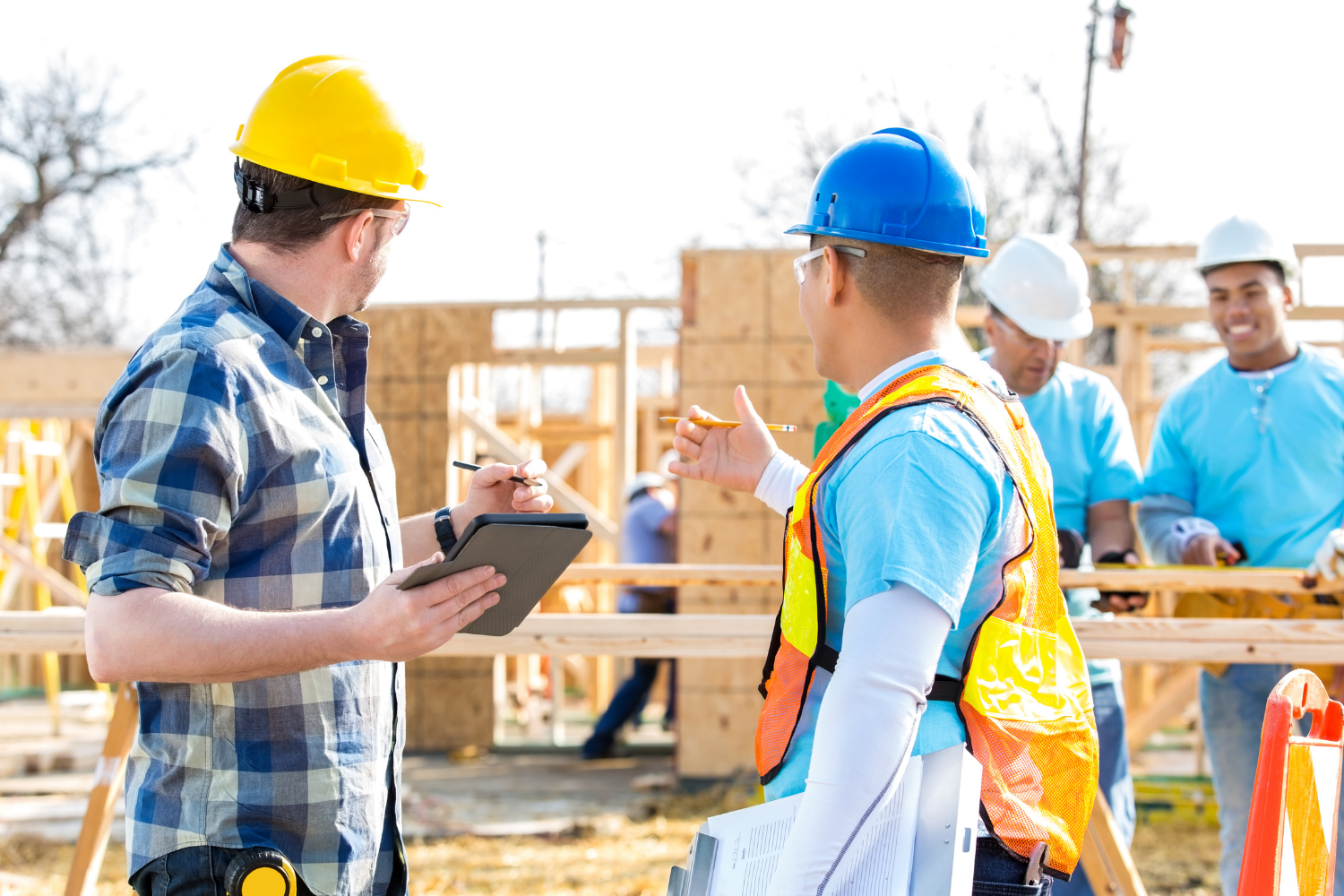Builders discussing project details on site to maintain cost control and construction quality