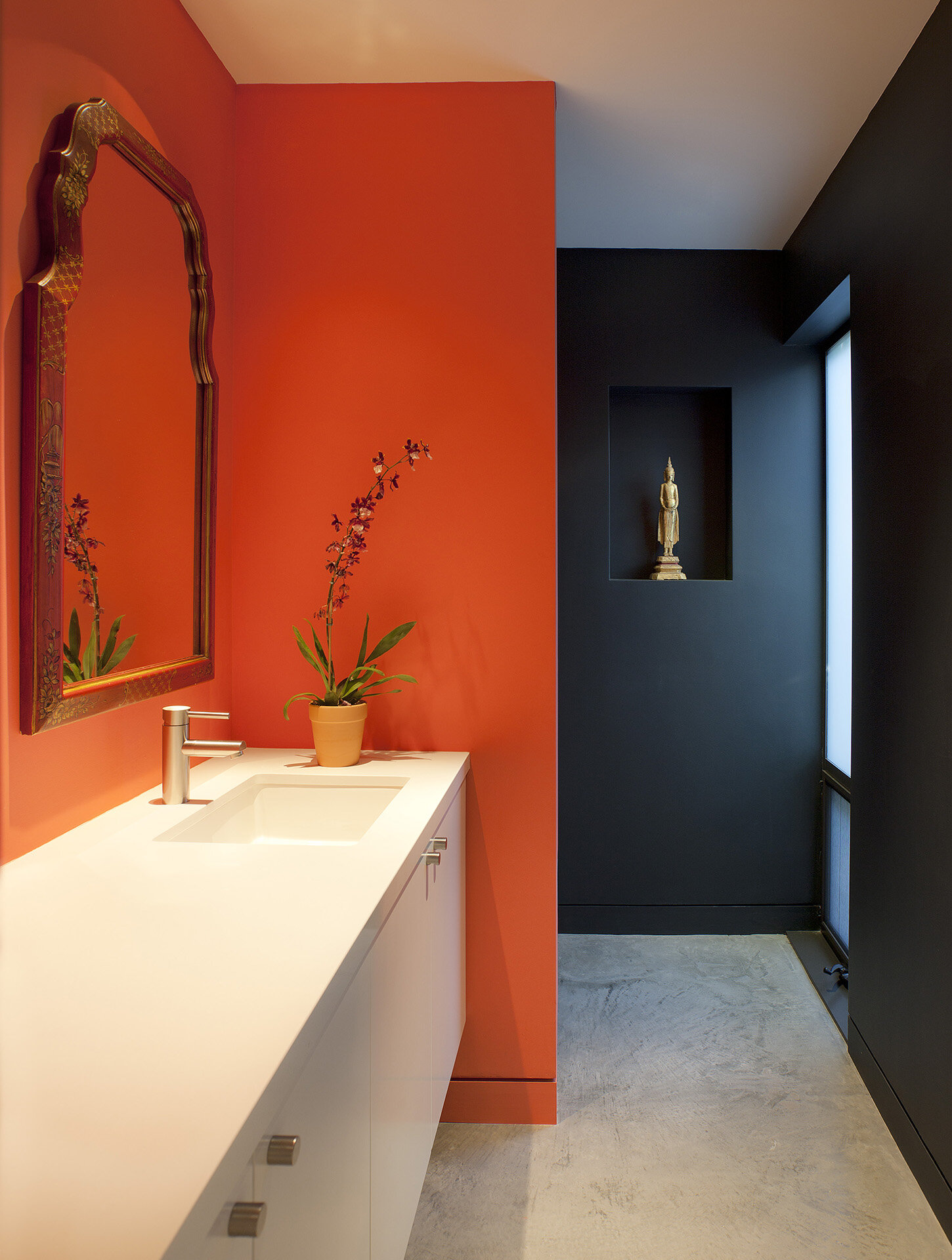  Top best luxury general contracting company modern home in a canyon neighborhood of Los Angeles featuring iconic design by architect Chu and Gooding featuring mid century style bathroom with orange and black walls.  