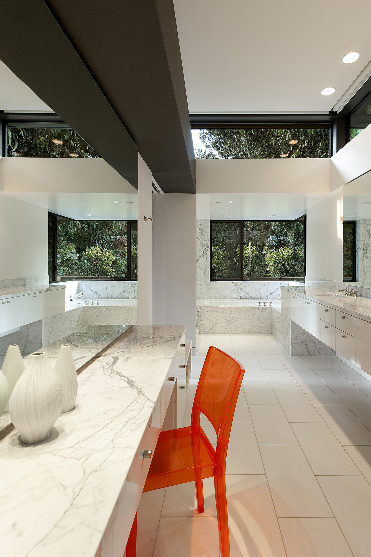  Top best luxury general contracting company modern home in a canyon neighborhood of Los Angeles featuring iconic design by architect Chu and Gooding featuring mid century style master bathroom suite with marble counters and clerestory windows.  