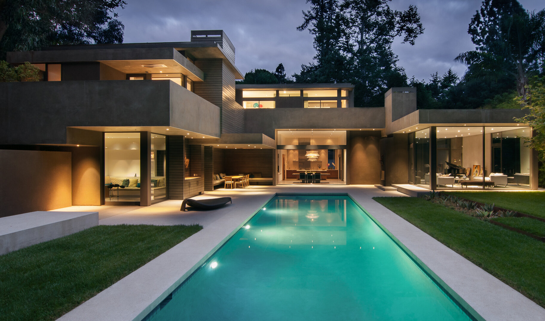 Top best luxury general contracting company modern home in a canyon neighborhood of Los Angeles featuring iconic design by architect Chu and Gooding with floor to ceiling glass windows, open floor plan, minimal pool, architectural quality.  