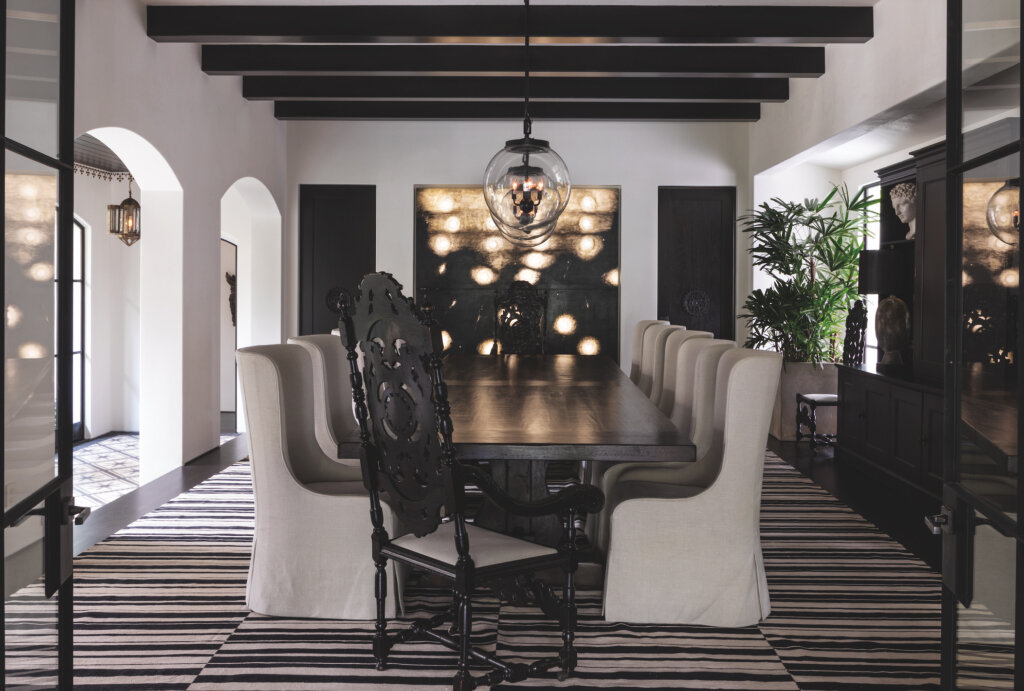  Custom luxury estate general contracting company Spanish Colonial California residence in the Beverly Hills neighborhood of Los Angeles featuring Moorish Moroccan dining room style with black wood ceiling beams and archway corridor.  