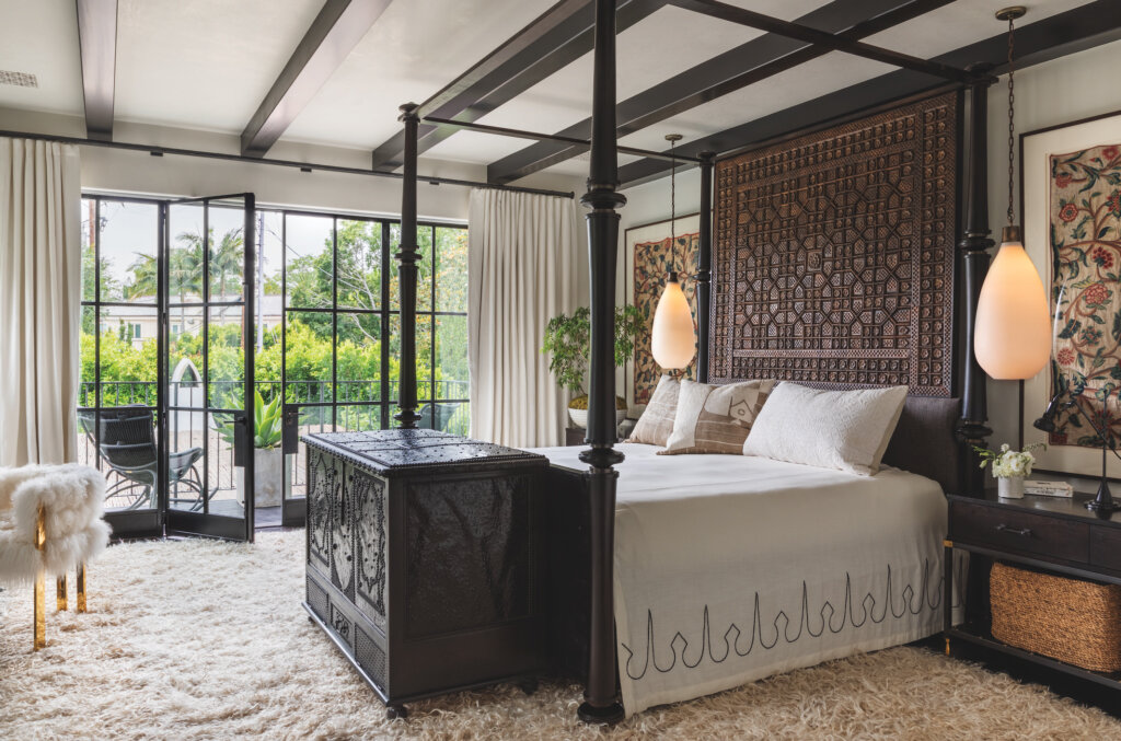  Custom luxury estate general contracting company Spanish Colonial California residence in the Beverly Hills neighborhood of Los Angeles featuring Bohemian contemporary bedroom style with shag carpet, wood ceiling beams, Moroccan four poster bed.  
