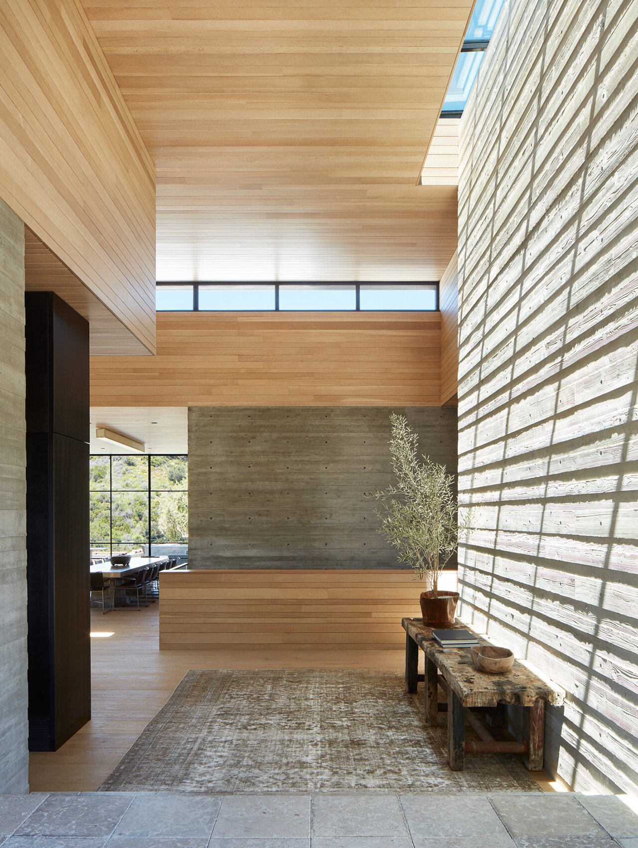  Custom luxury home builder constructed modern private residence in the Pacific Palisades neighborhood of Los Angeles featuring open layout, board form concrete walls, wood walls.  