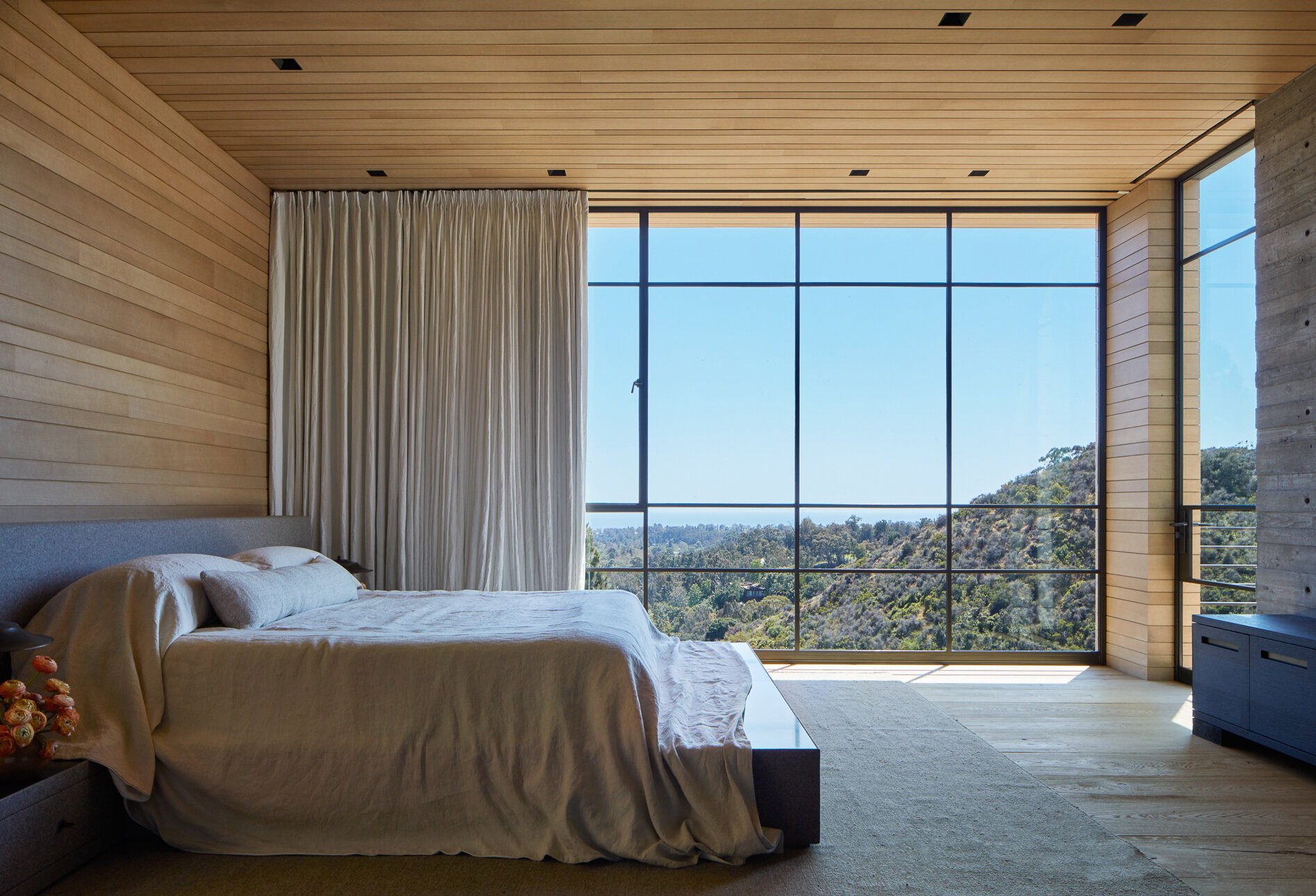  Custom luxury home general contractor built modern private residence in the Pacific Palisades neighborhood of Los Angeles featuring steel frame windows and wood panel walls with iconic views.  