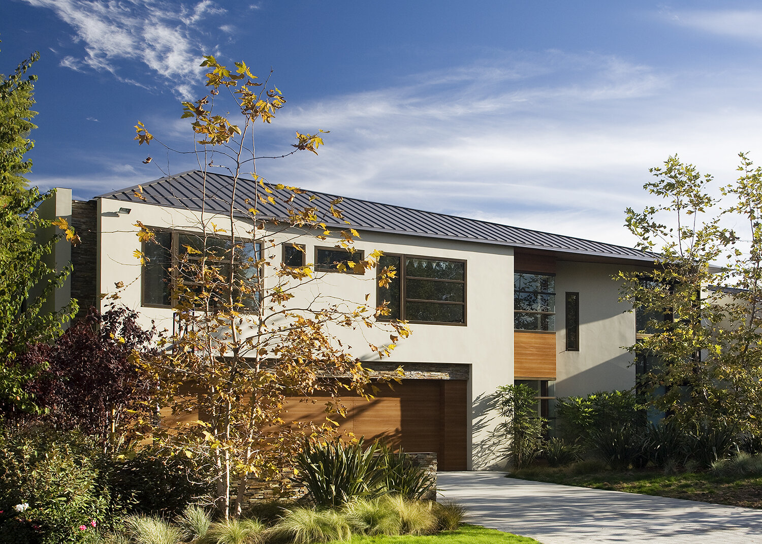  Contemporary general contractor built custom architectural home in the Pacific Palisades neighborhood of Los Angeles featuring modern roof and garage.  