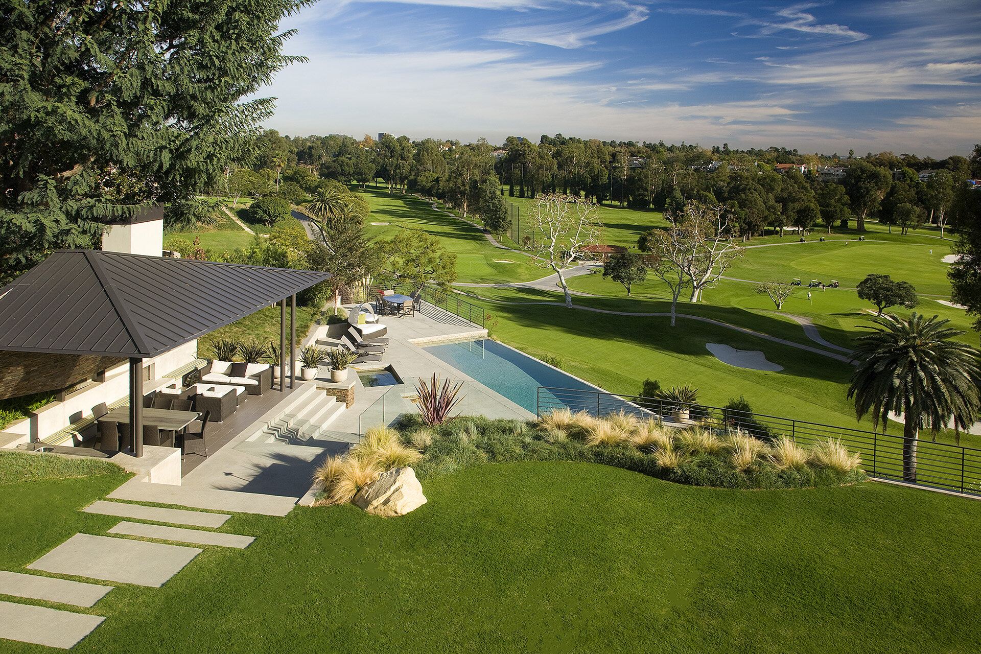  Contemporary general contractor built custom architectural home in the Pacific Palisades neighborhood of Los Angeles featuring outdoor terrace living room overlooking golf course.  