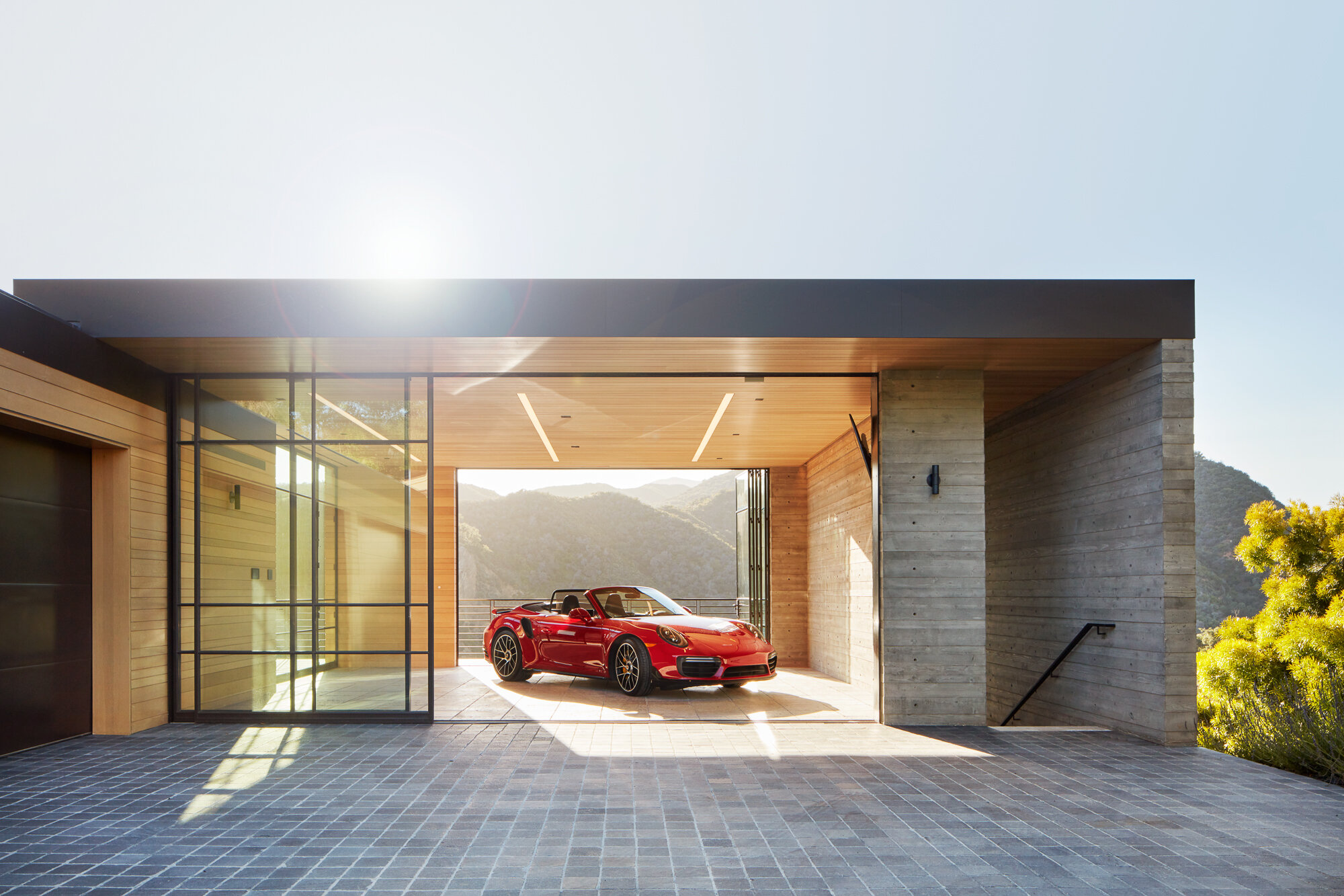  Custom luxury home general contractor built modern private residence in the Pacific Palisades neighborhood of Los Angeles featuring high end living room garage for vintage car collection with architectural qualities.  