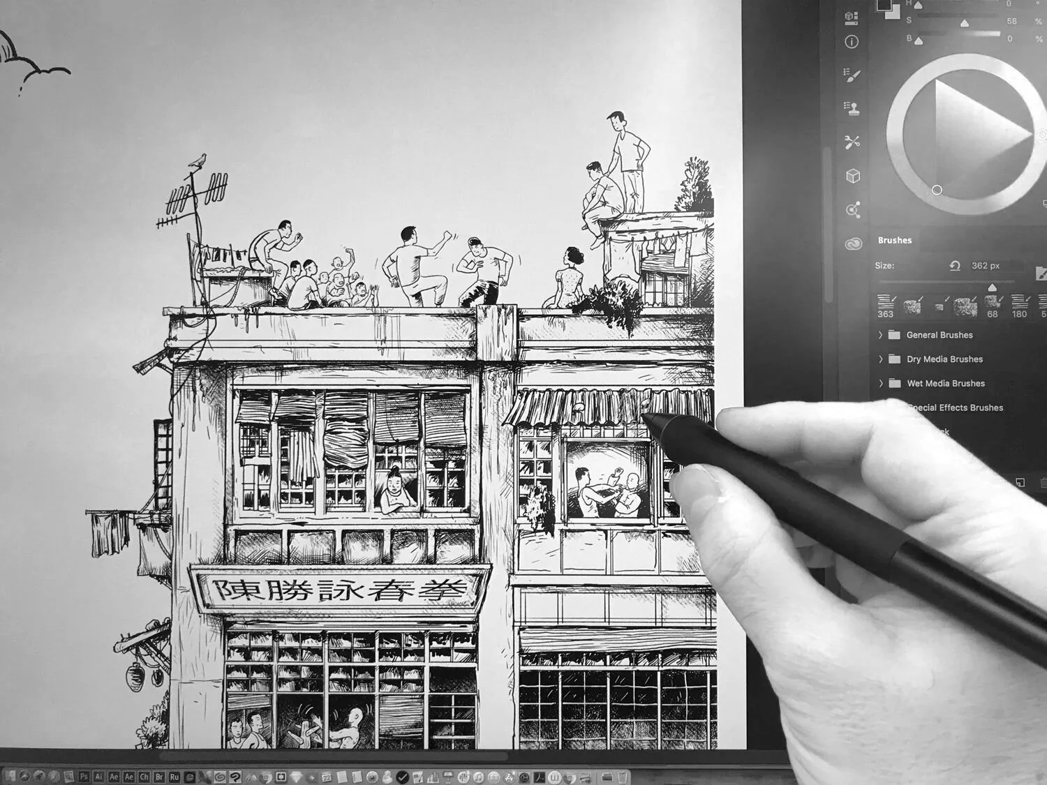 Black and white digital drawing of a multi-story building with various people engaging in activities on the roof, inside, and outside. Hand holding a stylus working on the drawing on a screen.