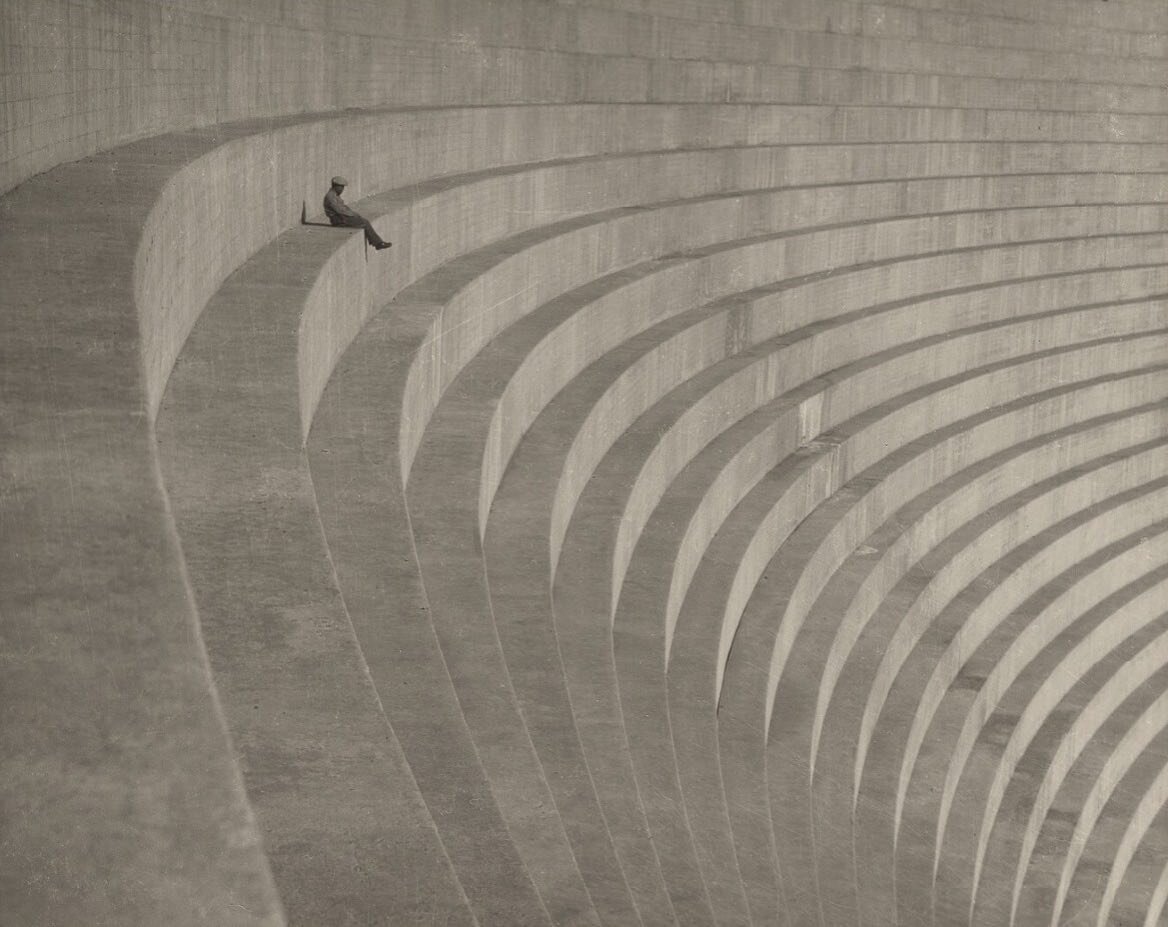 The Thinker by Hiromu Kira, circa 1930, photo of man seated on the stepped concrete side of the Mulholland Dam, Los Angeles, Calif.