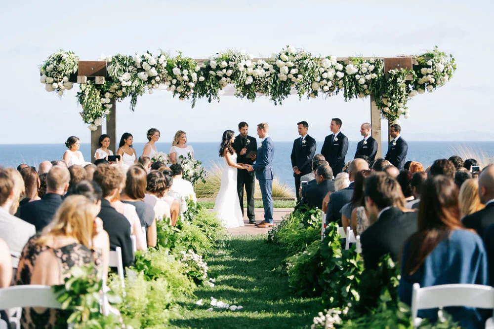 aboutdetailsdetails.com | Brandon Kidd | LA Wedding Planner | Catalina Point Wedding | Wedding Ceremony Inspiration | Ocean Backdrop | Oceanfront Wedding | Greenery with White Flowers | Lush Garlands | Garland Lined Wedding Aisle