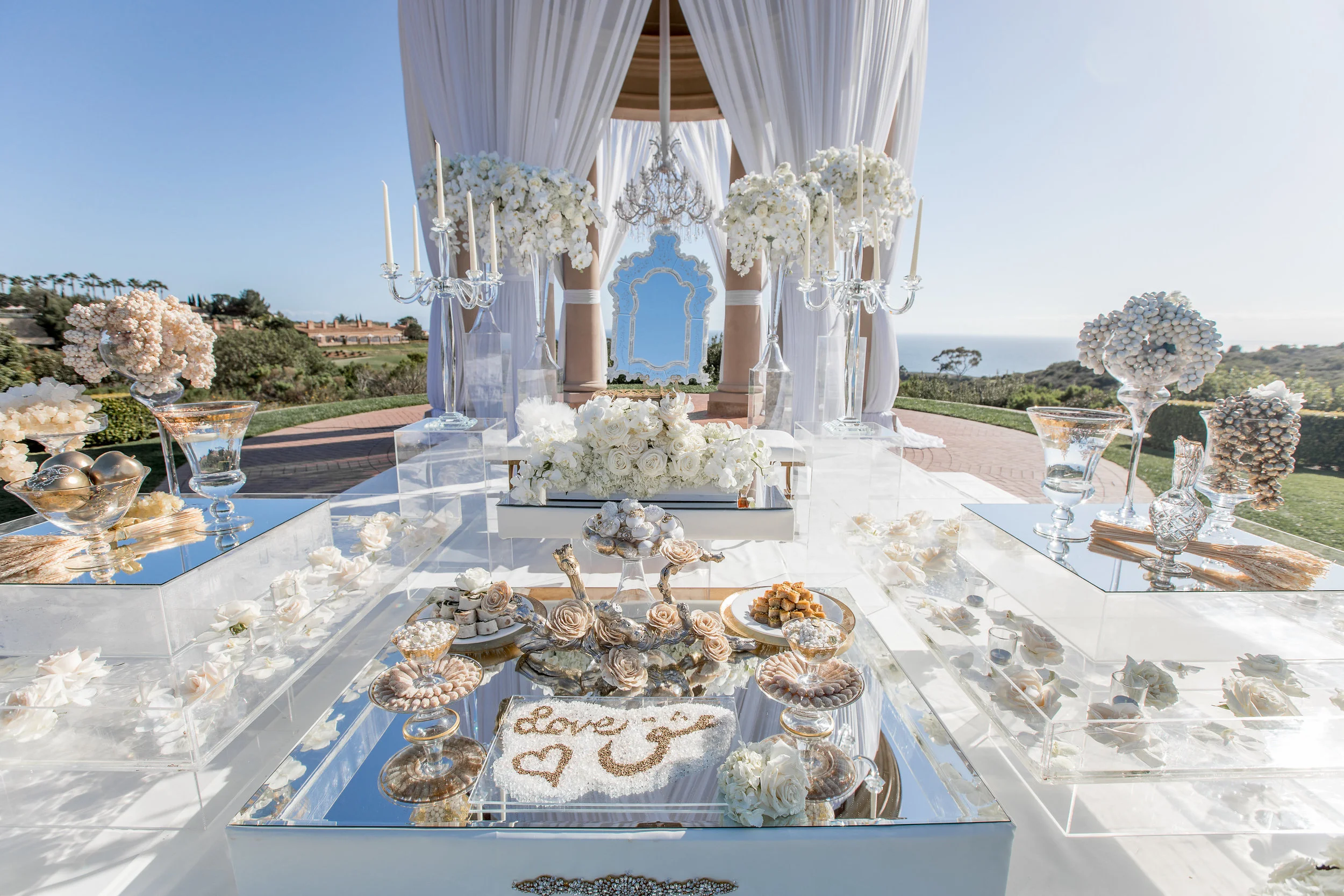 Aboutdetailsdetails | Katie Beverley Photography | Pelican Hill | Ocean View | Rotunda | White draping | White orchid | Glass vases | White roses | Candelabras | Dessert table | Sweets | Mirrors