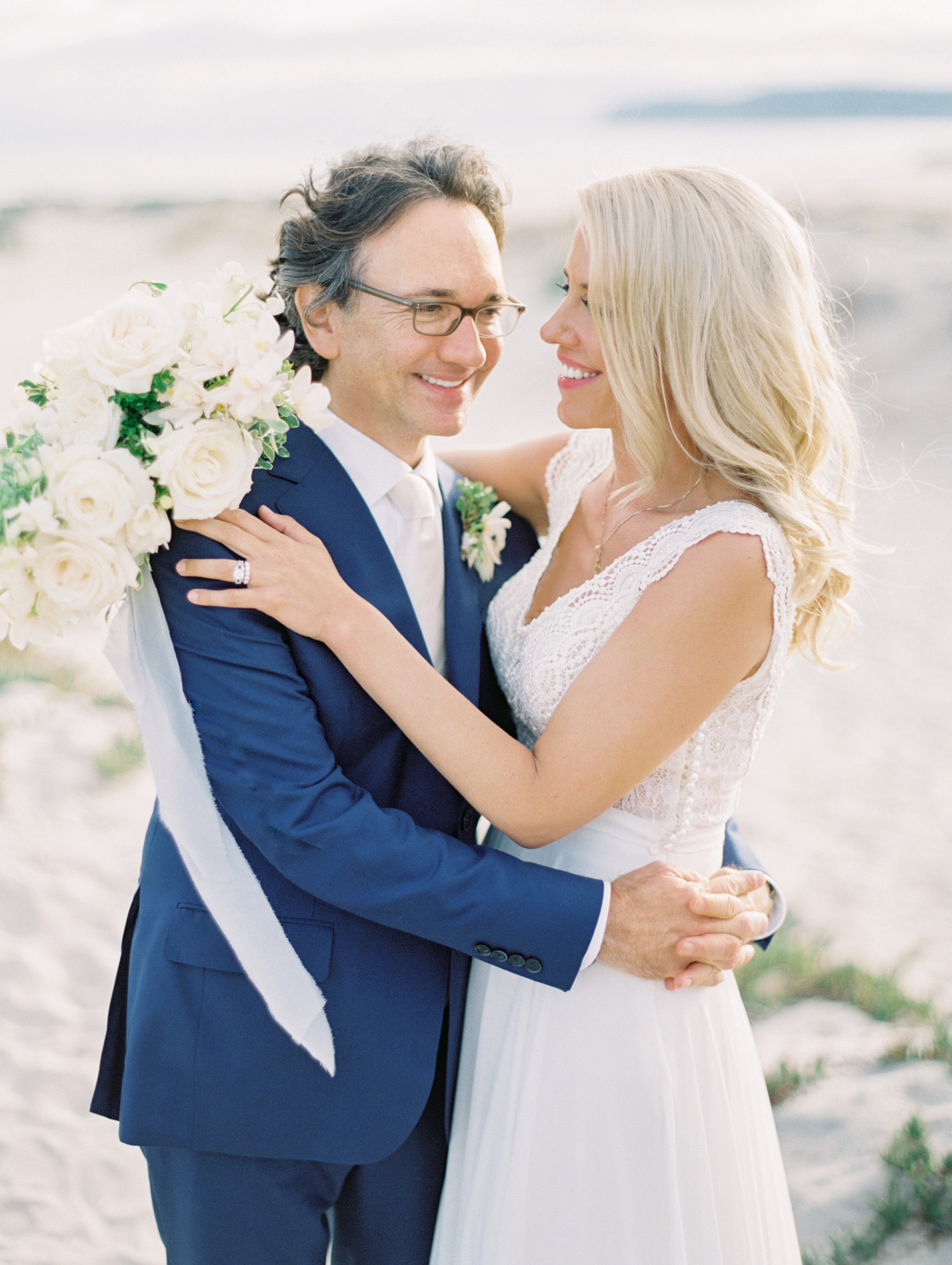 | Aboutdetailsdetials | Bride and Groom | White Roses | Navy | Lace Wedding Dress | Floral Hairpiece | Diamond and Sapphire |
