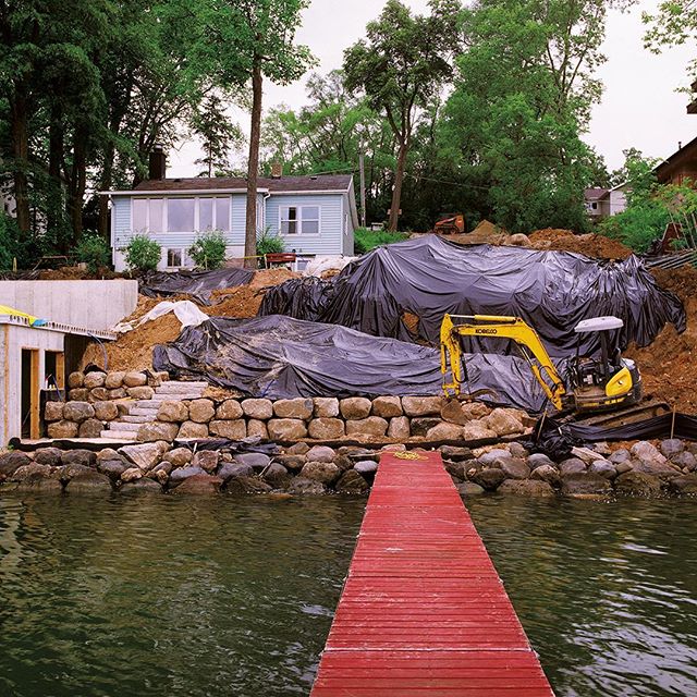 Lakeside view of Lake Cottage #26 from LITTLE HOUSE ON THE LAKE. This was taken just before demolition and illustrates a bit of the process of building on the lake. You reinforce the shoreline, then comes the boathouse and landscaping, then work your