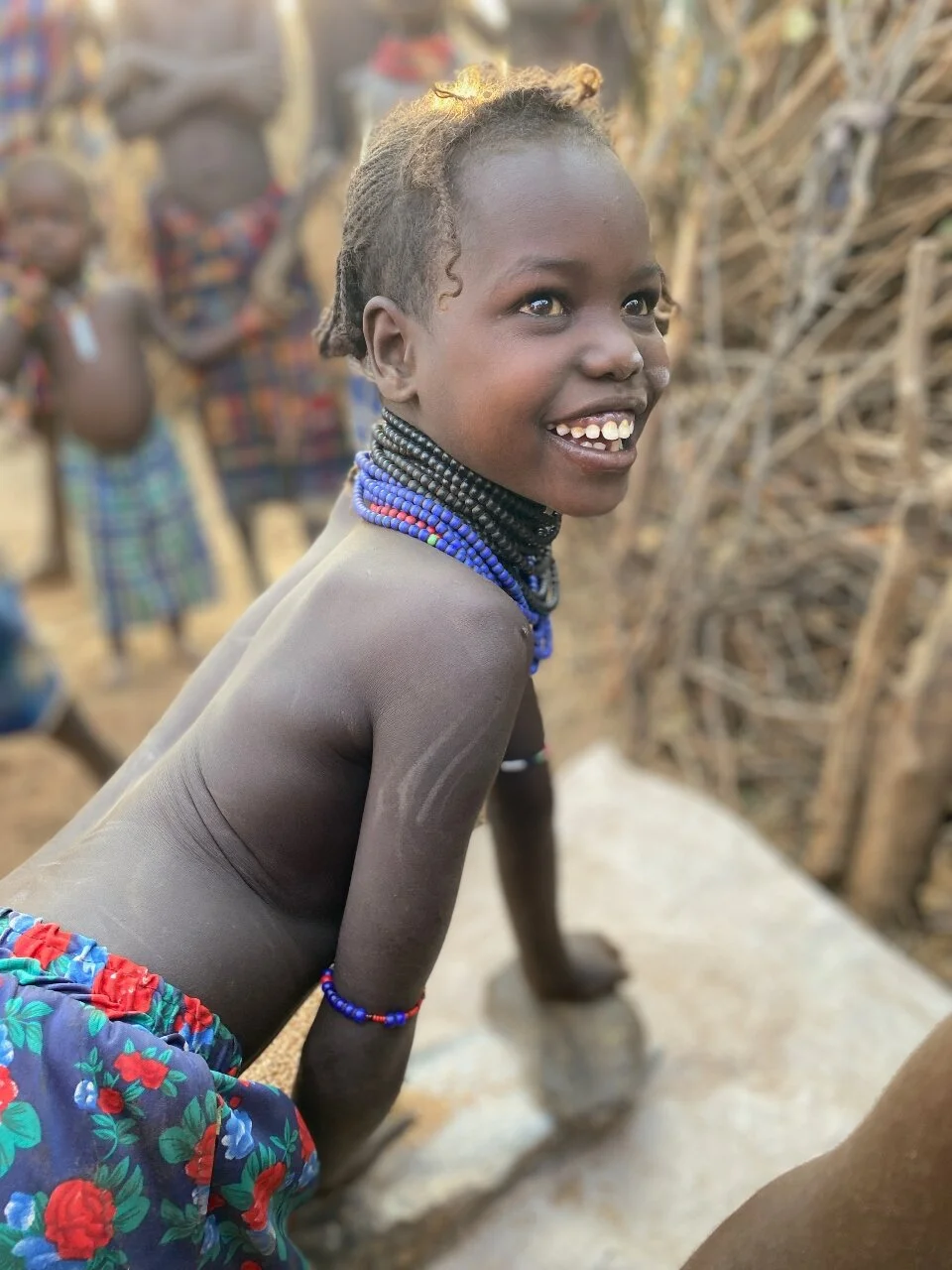 A young girl mills grain 