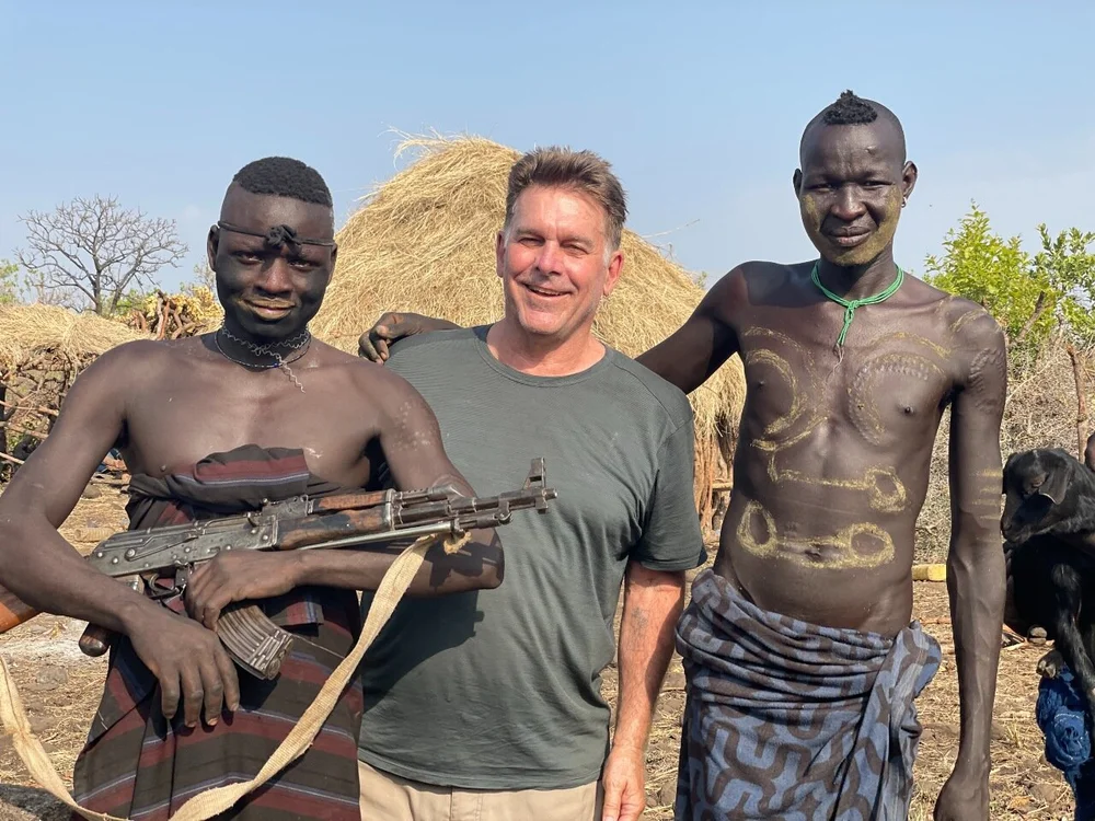 scott with mursi boys.jpeg