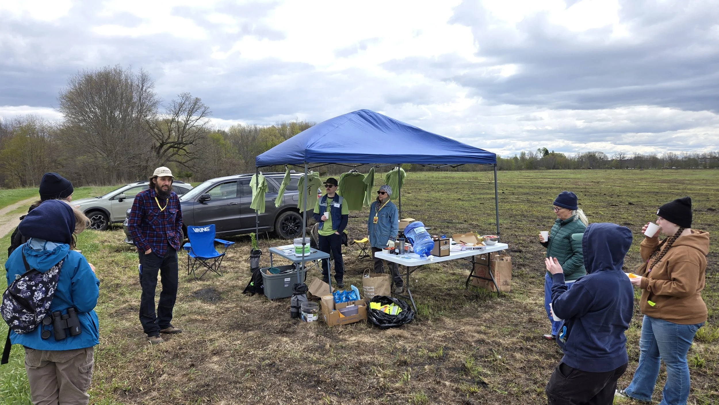  Josh Kieser (board president), providing a volunteer orientation. Board members, Tom Howes and Judy Huxmann, standing in tent.  