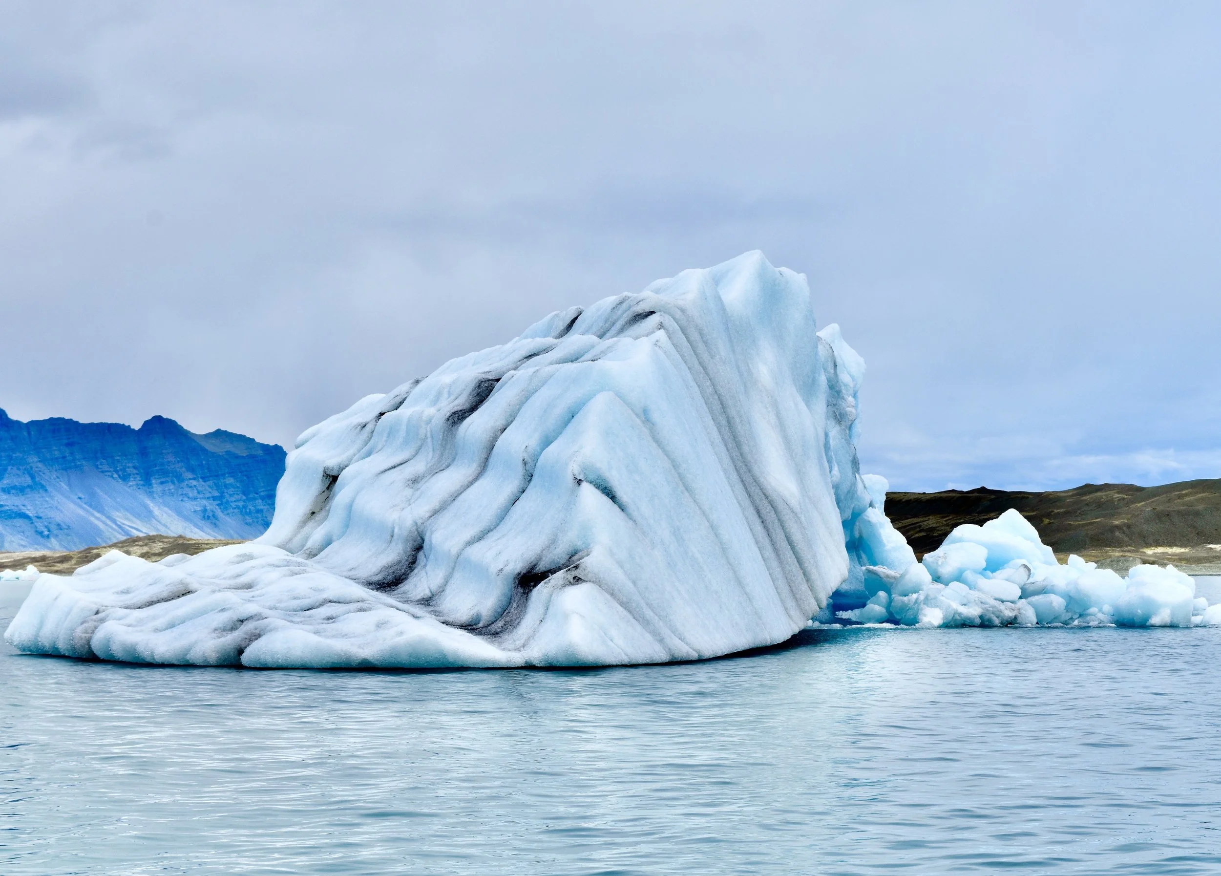  Iceberg calved from Breiðamerkurjökullglacier, Iceland. The striations are layers of snow and ash from volcanic eruptions.  Photo courtesy of S. Medenieks . 