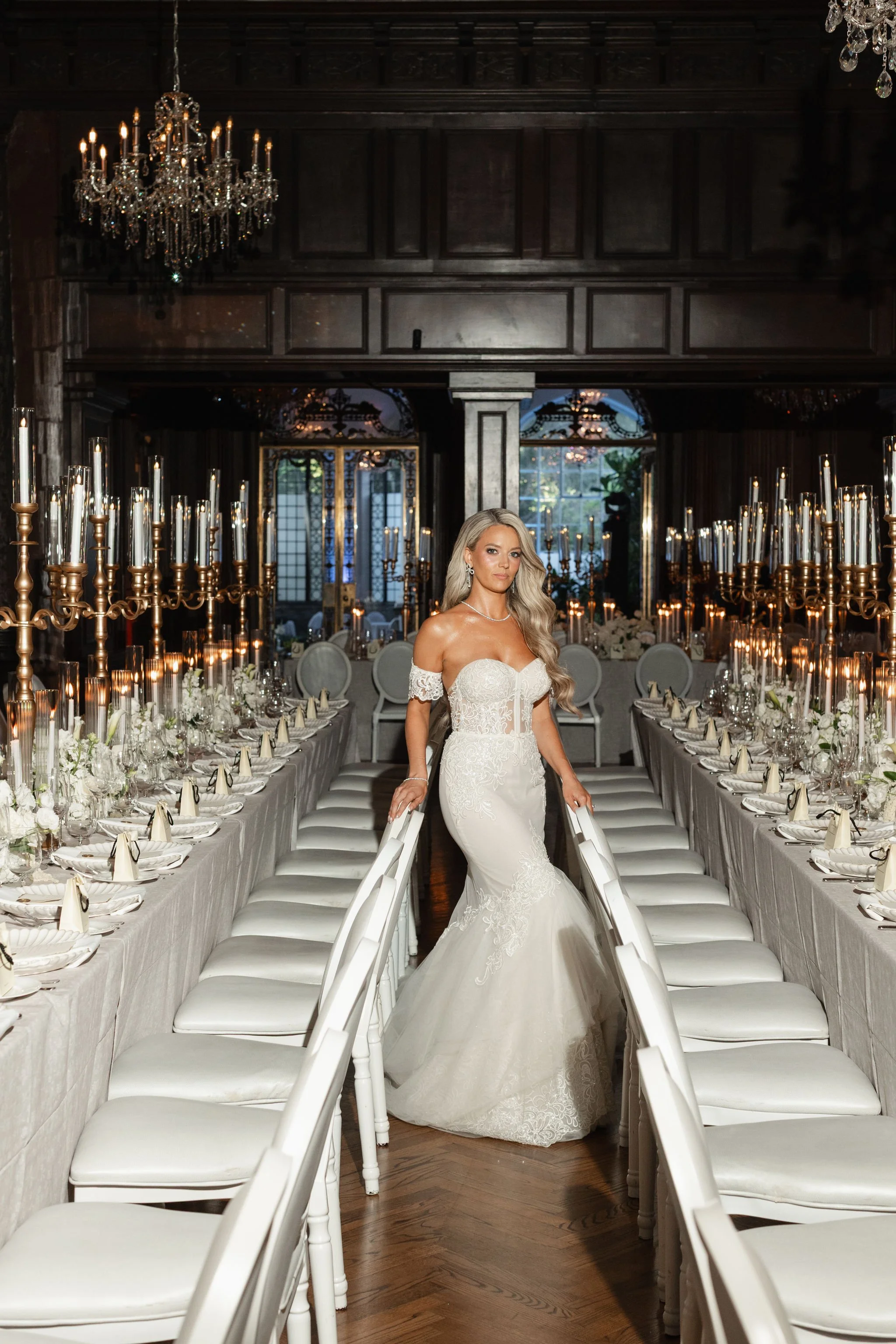 A Toronto Blonde bride stands in the middle of her Casa Loma wedding