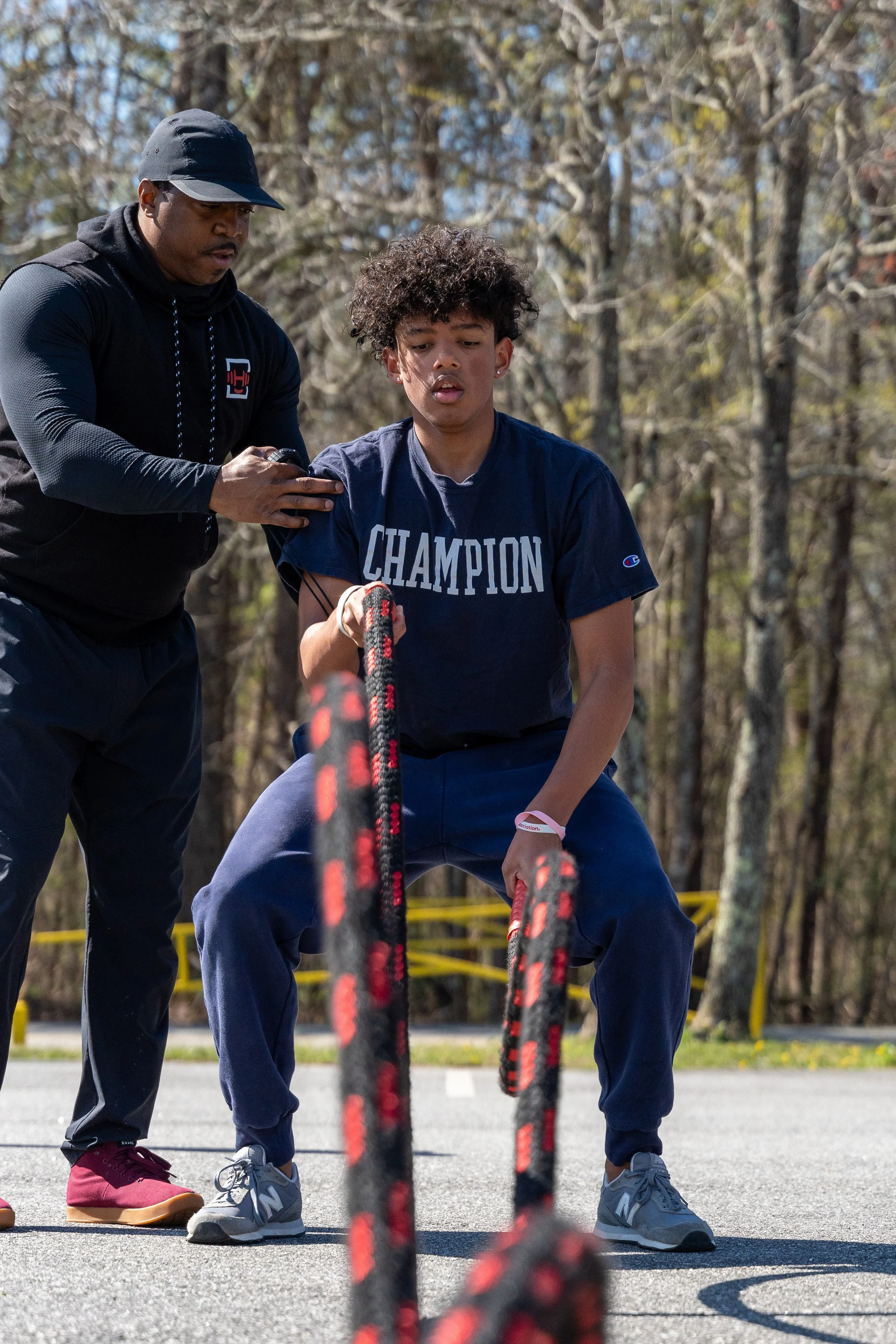 MJ Fit Training participants working together during an outdoor rope exercise.