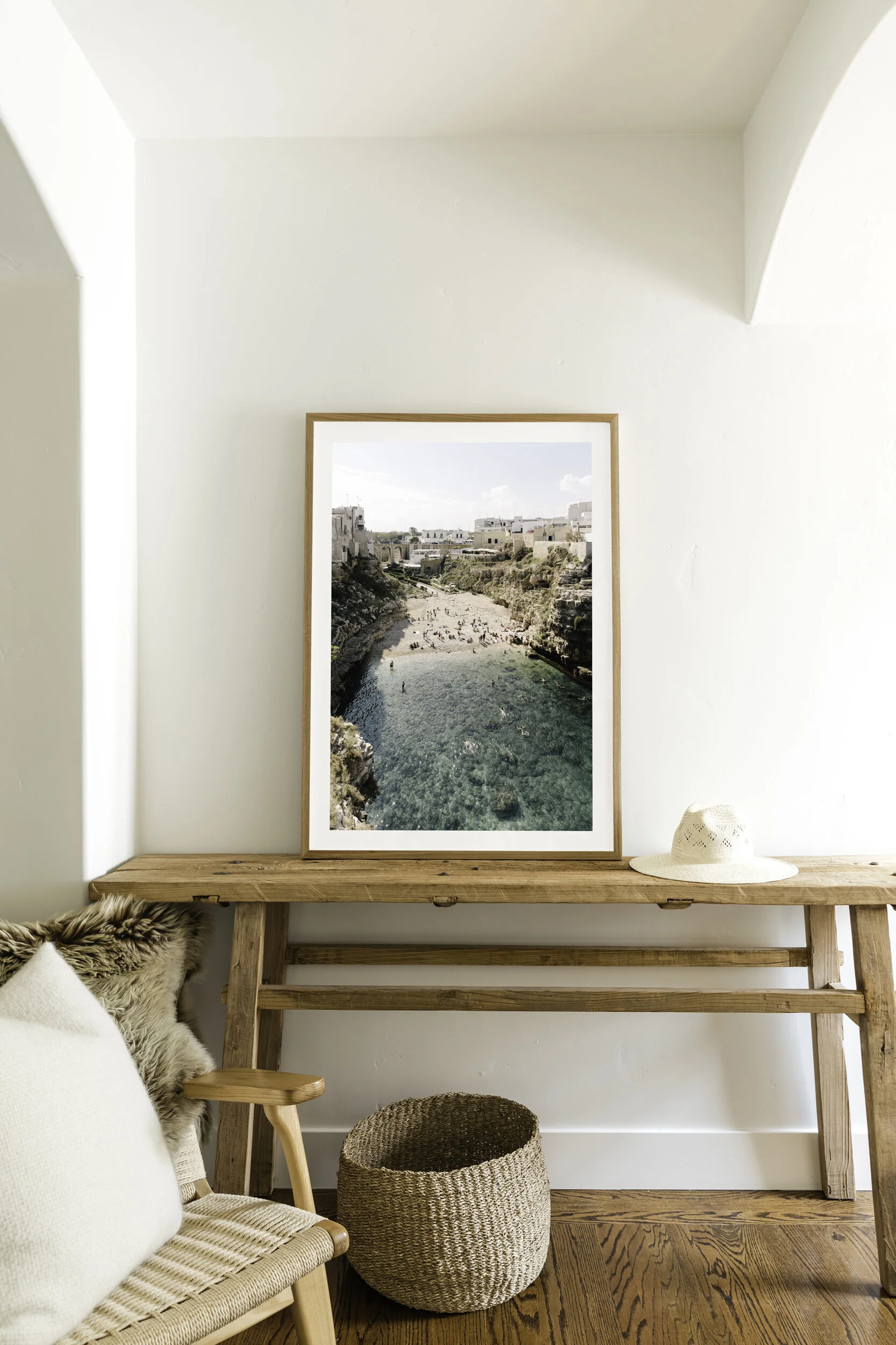 aerial image of famouse italian beach in Polignano a mare framed with mat sitting on modern farmhouse table