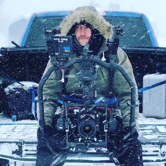 Tim Boydell operating a Ronin 2 with a RED camera from the back of a pickup in the snow