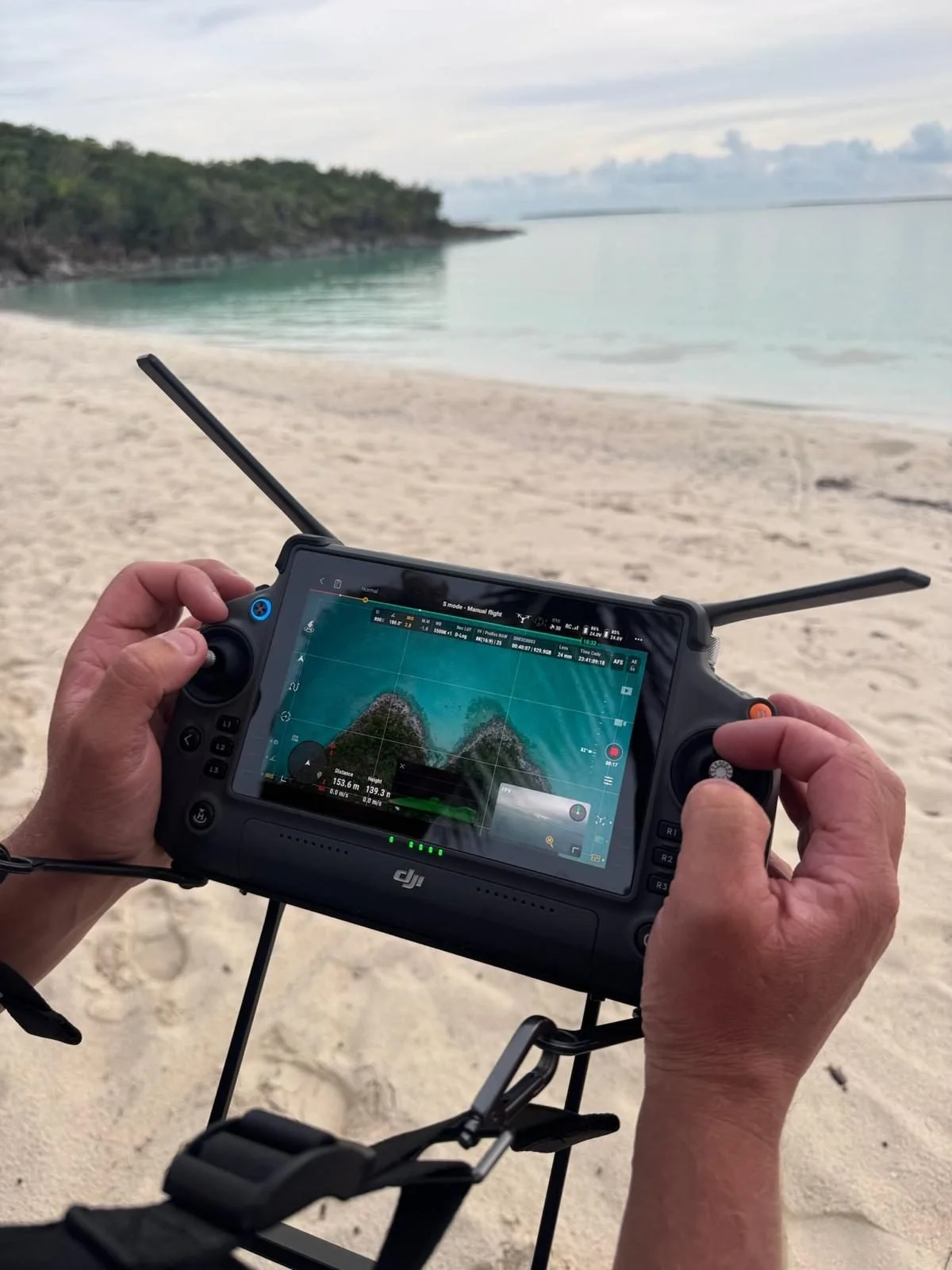 Pilot flying the DJI Inspire 3 on the RC Plus during a beach shoot in Cornwall