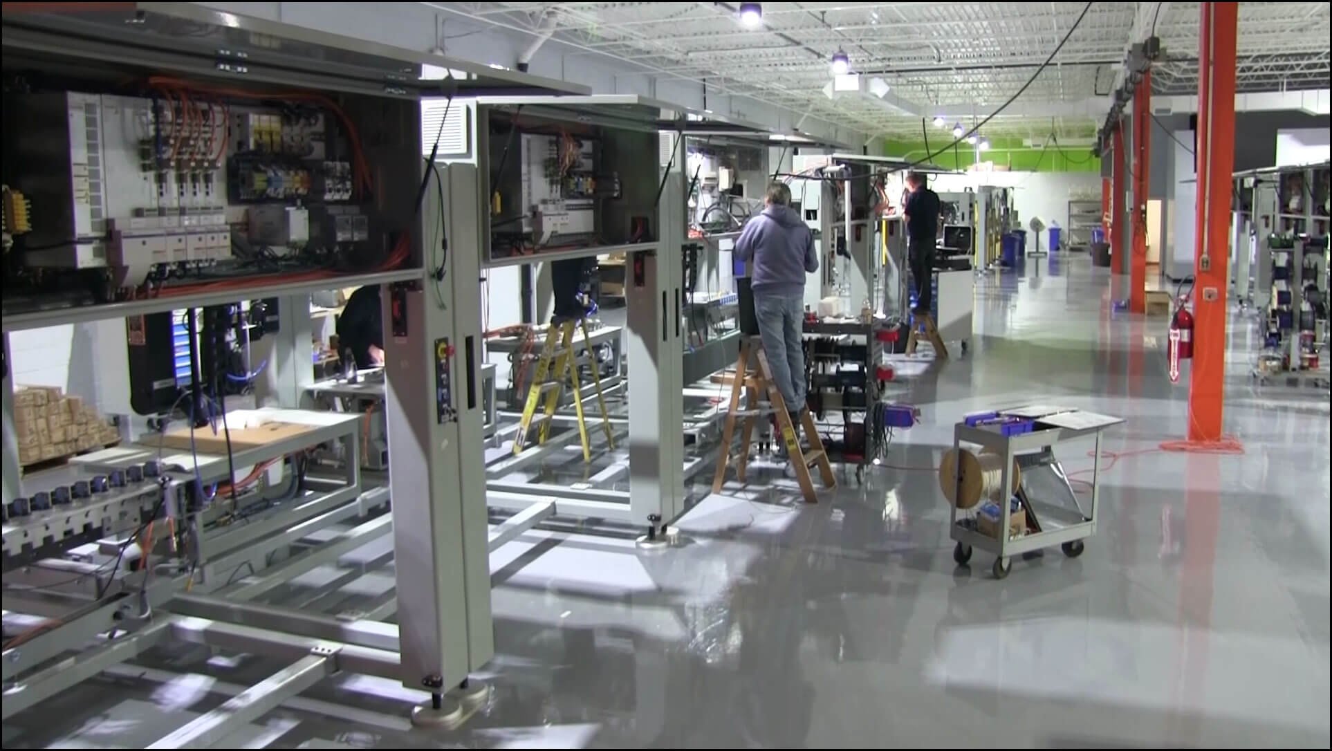 Men working on the modular frame control panels at IASE