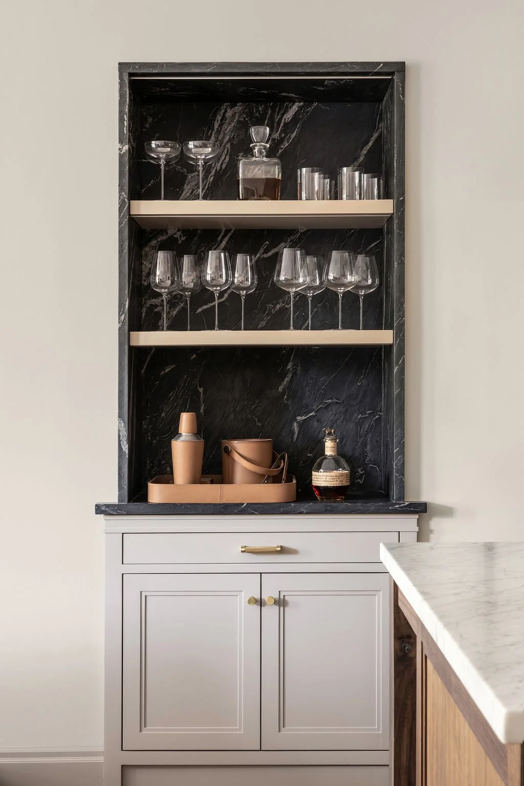 Black soapstone wet bar with glass shelving