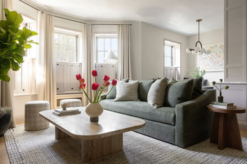 Living room with sage green sofa and window seat