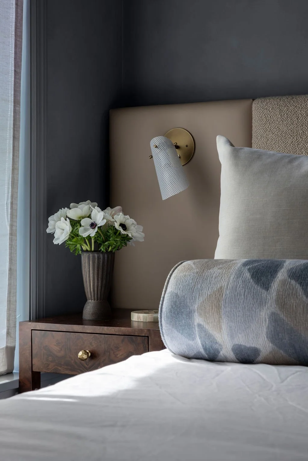 Primary bedroom nightstand and sconce