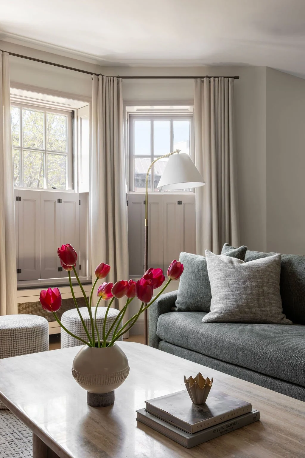 Living room window seat with coffee table flowers