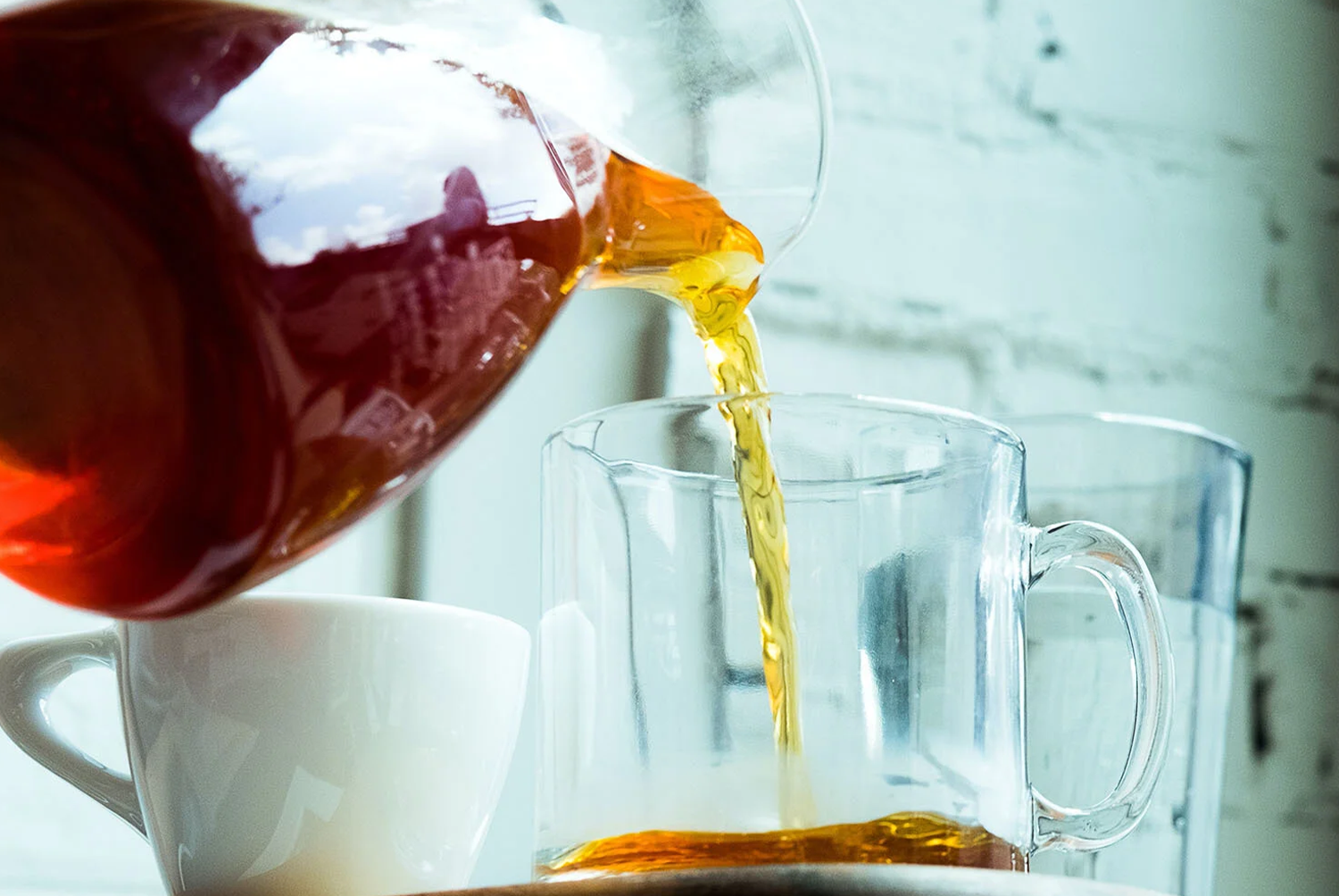Tea being poured in a glass