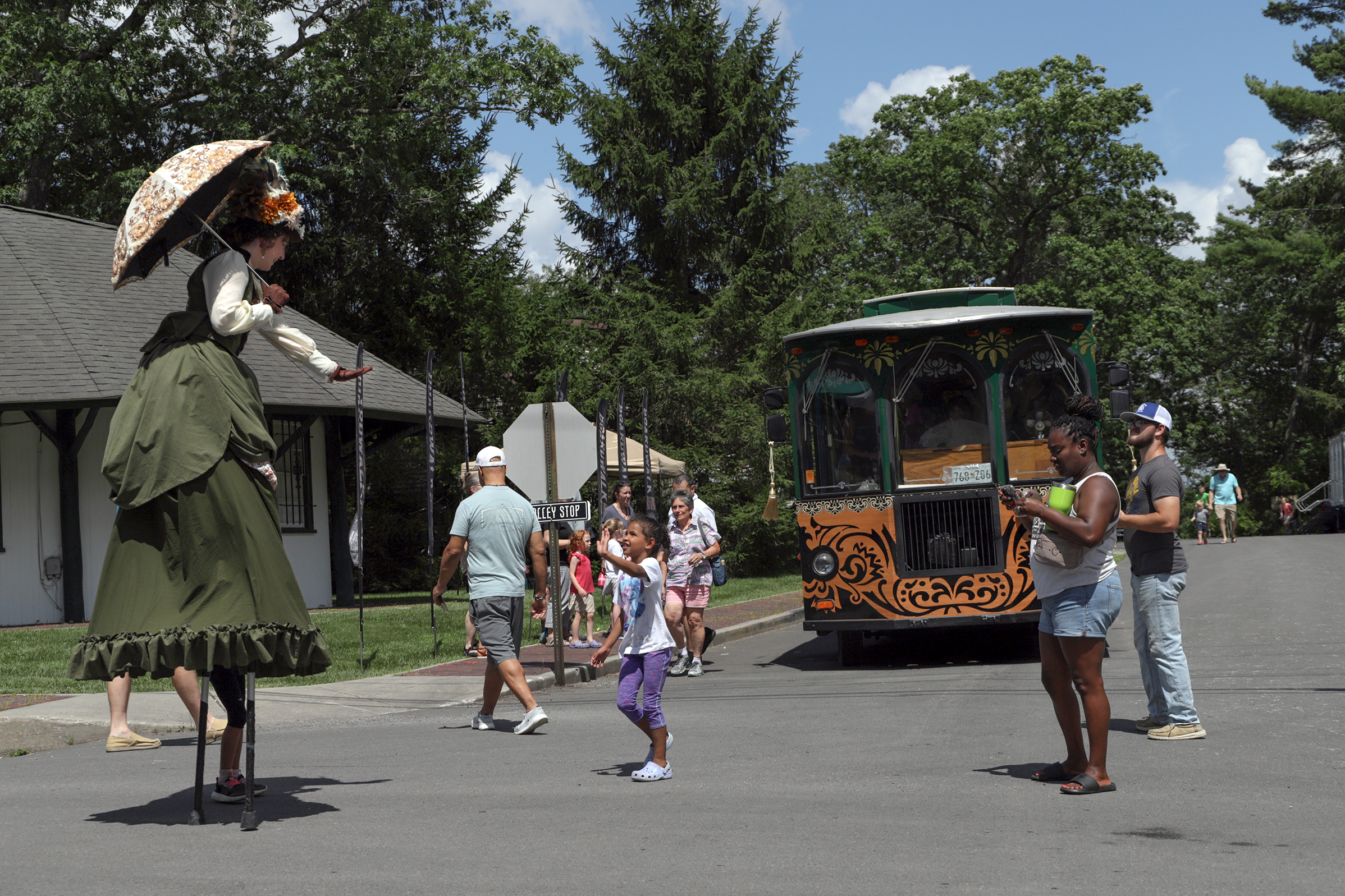 Stilt Walker Dakota Fox offers very high-fives
