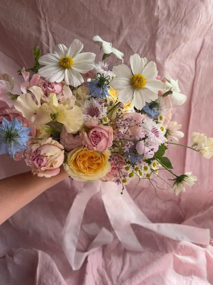 A beautiful display of early Summer for Meg. 
Composed of grandiflora roses, lisianthus, cosmos, carnations and beautiful stems of roses, sweetpeas, chamomile, corncockle, nigella, gyp and cornflowers from my garden.

Beautiful silk ribbon streamers 