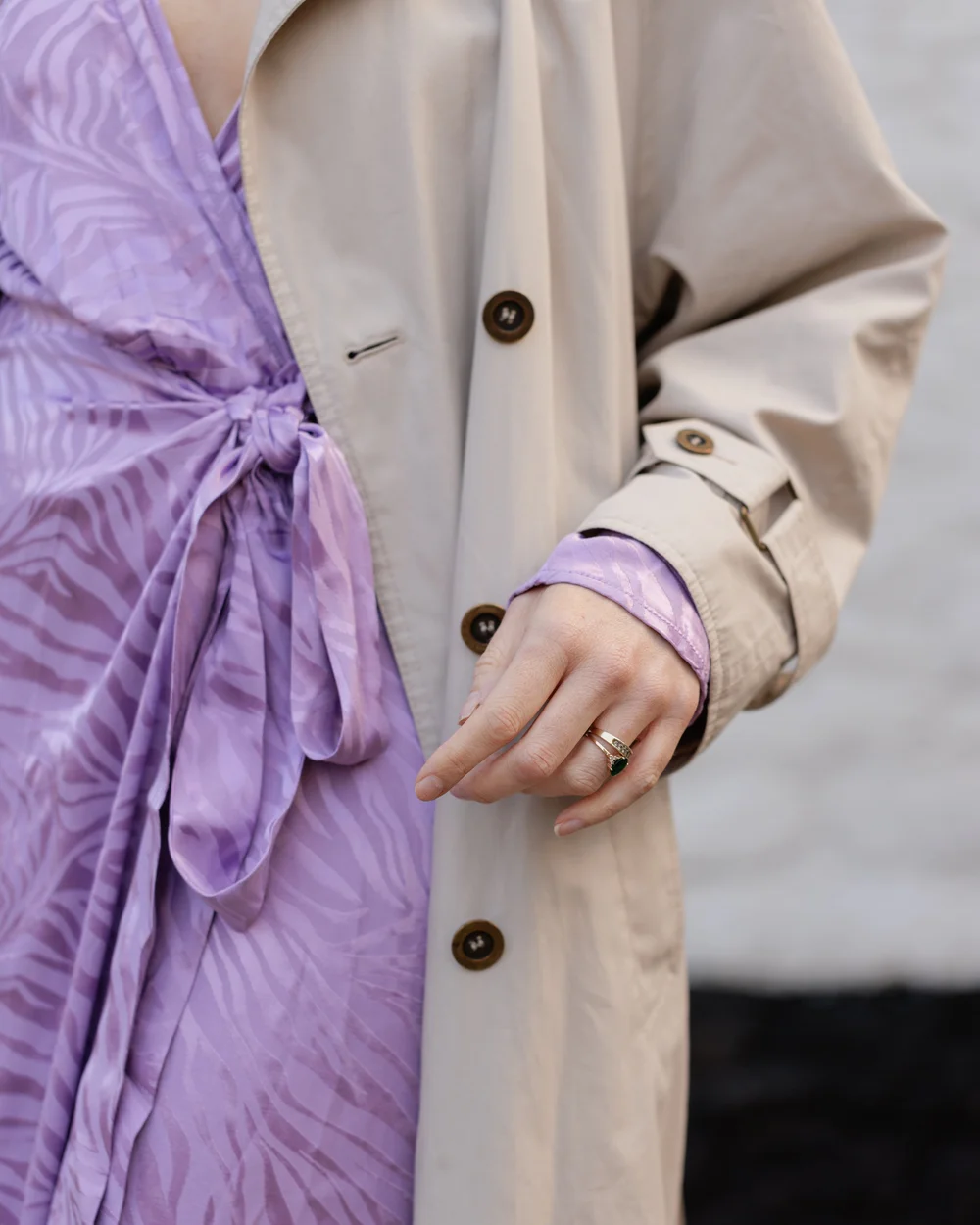 Close up of lilac wrap dress and trench coat