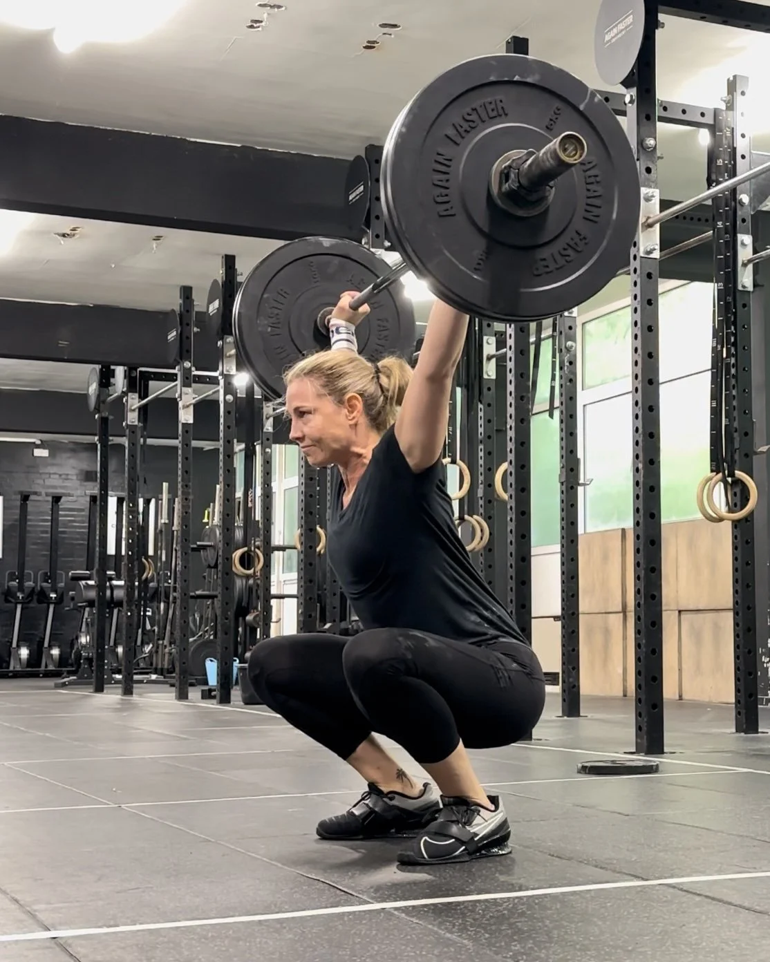 woman is doing olympics lifting in the gym