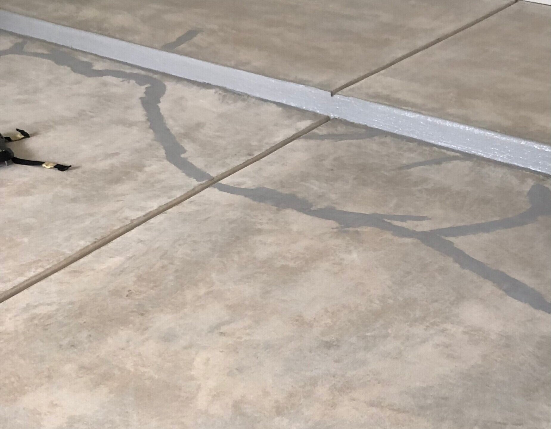 Uni-Gel crack repair epoxy installed on cracks in a garage floor