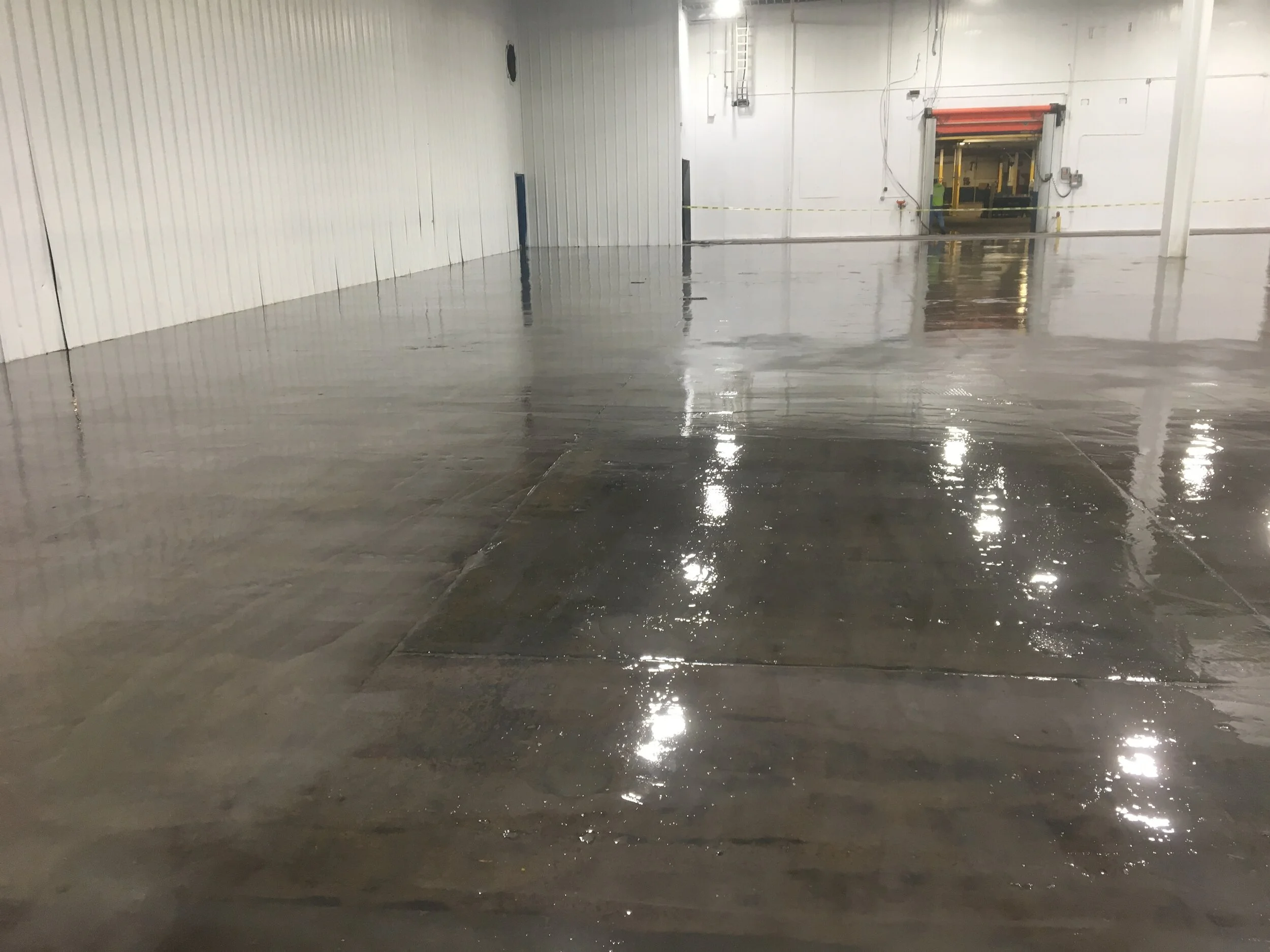 Uni-Level self leveling epoxy system installed in a warehouse with overhead doors
