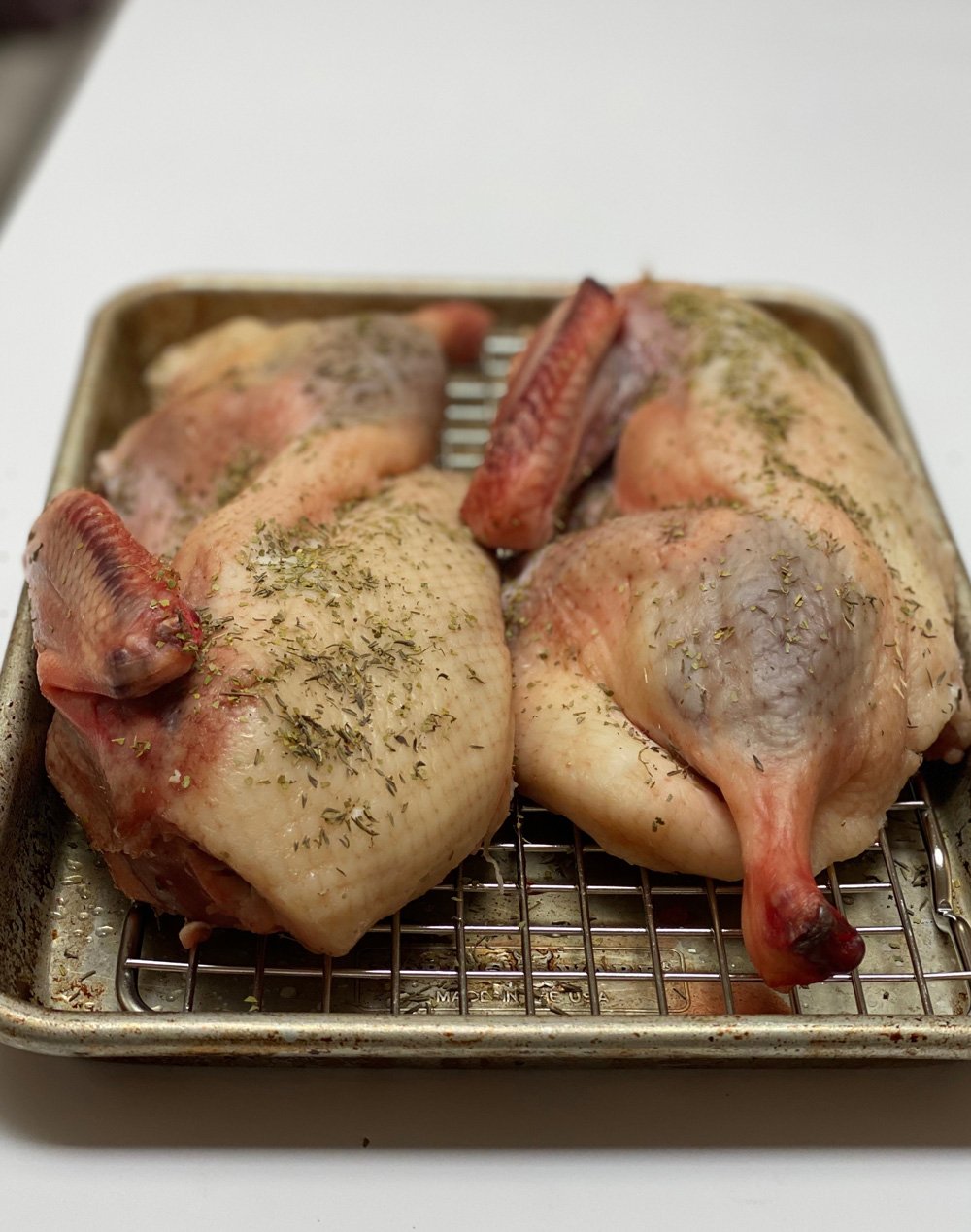 The herbs spread out on the top of the duck.