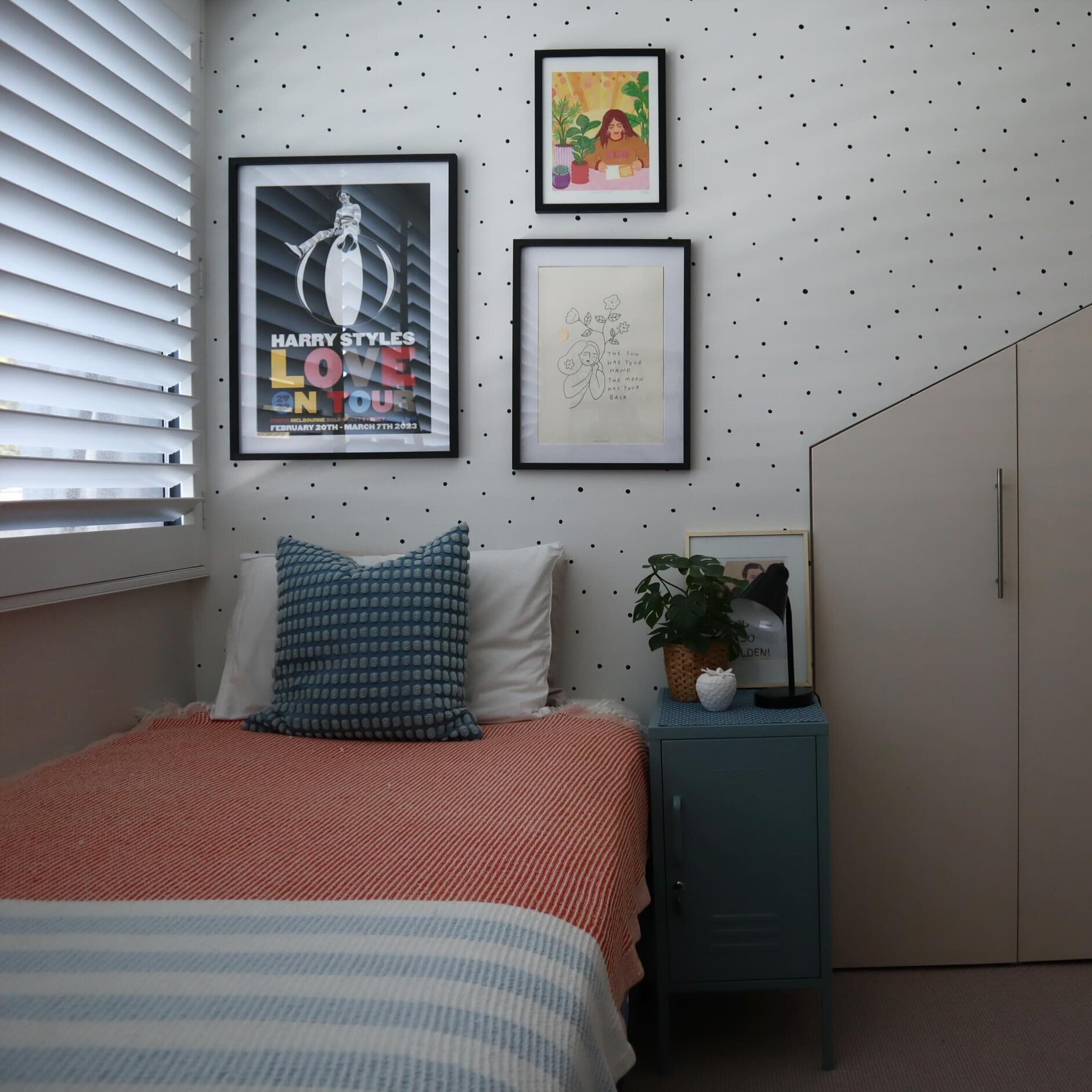 Cute spotty wallpaper is the perfect backdrop for this tween bedroom.