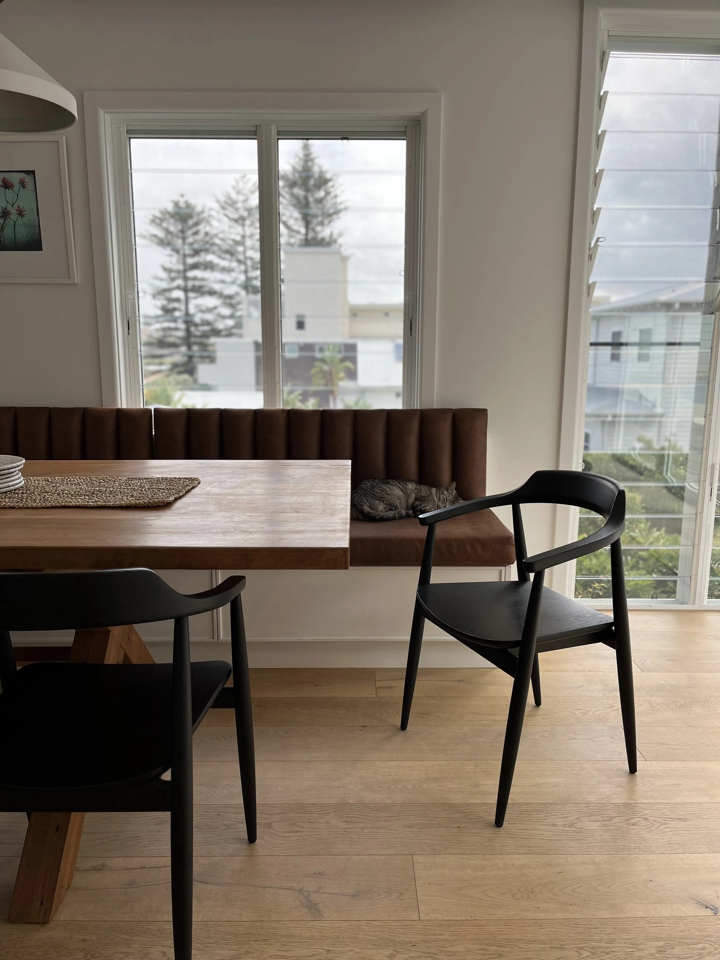 Leather banquette and timber chairs.jpeg